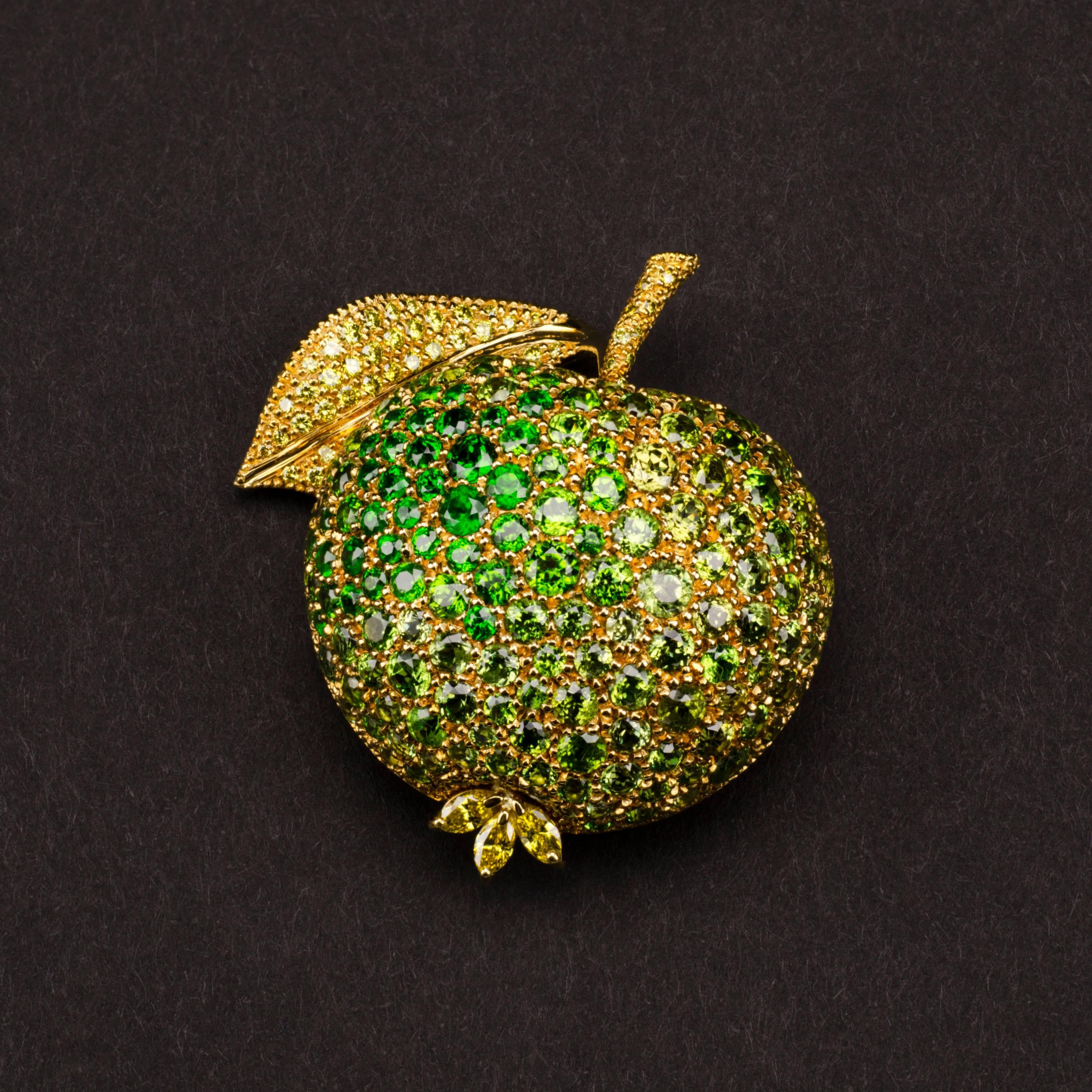 ‘You are the apple of my eye’, a quote perhaps best known for its romantic Shakespearian origins in A Midsummer Night’s Dream.
This 18ct yellow gold brooch from Henn, featuring the rarest demantoide garnets from Pakistan, is a fitting tribute to the
