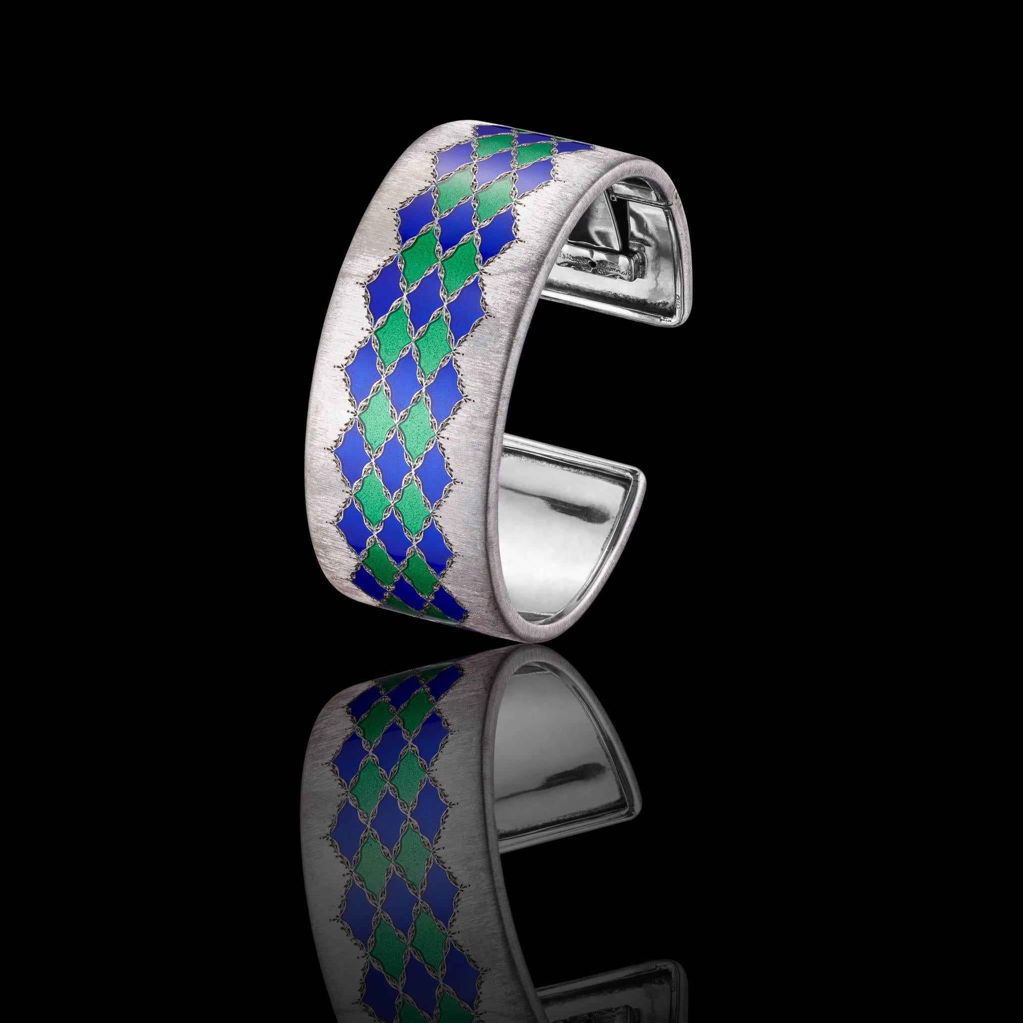 Gianmaria Buccellati Bangle of textured silver decoreted with blue and green lozenge-shaped enamel motifs.
Size/Dimensions:5,9 diameter/2,7cm at the widest point.
SiGNATURE:Gianmaria Buccellati ,Italy.
Marks:925.
