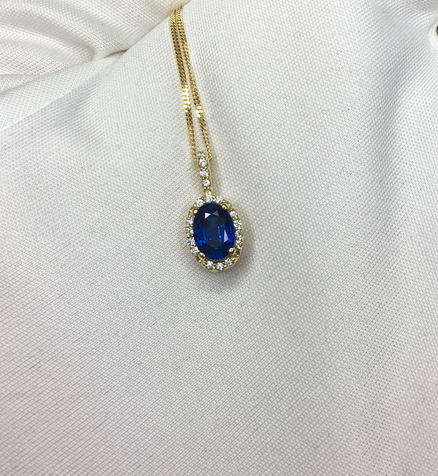 Stunning natural deep blue Ceylon sapphire set in a fine 18k yellow gold diamond cluster/halo Pendant. 

1.00 carat centre sapphire with stunning blue colour and very good clarity.

Surrounded by 0.101ct of colourless diamonds with G/H colour and