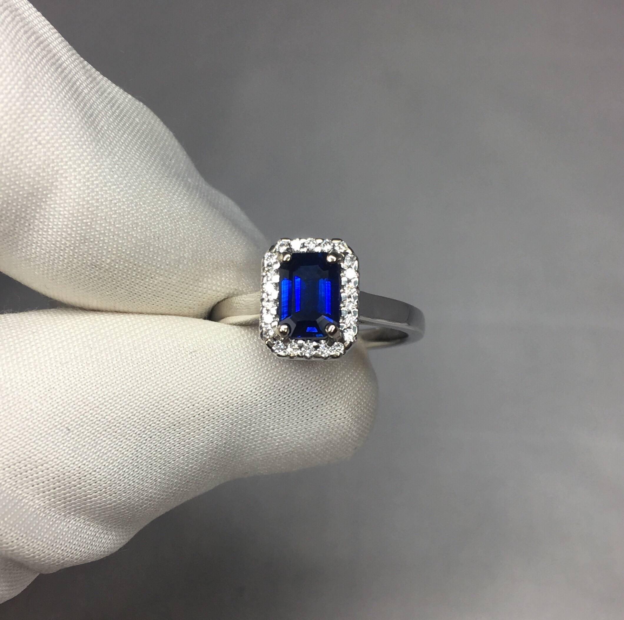 Stunning natural deep blue Ceylon sapphire set in a fine 18k white gold diamond cluster ring. 

1.00 carat centre sapphire with a fine deep but vivid blue colour and excellent clarity.

Also has an excellent emerald cut which shows the fine colour