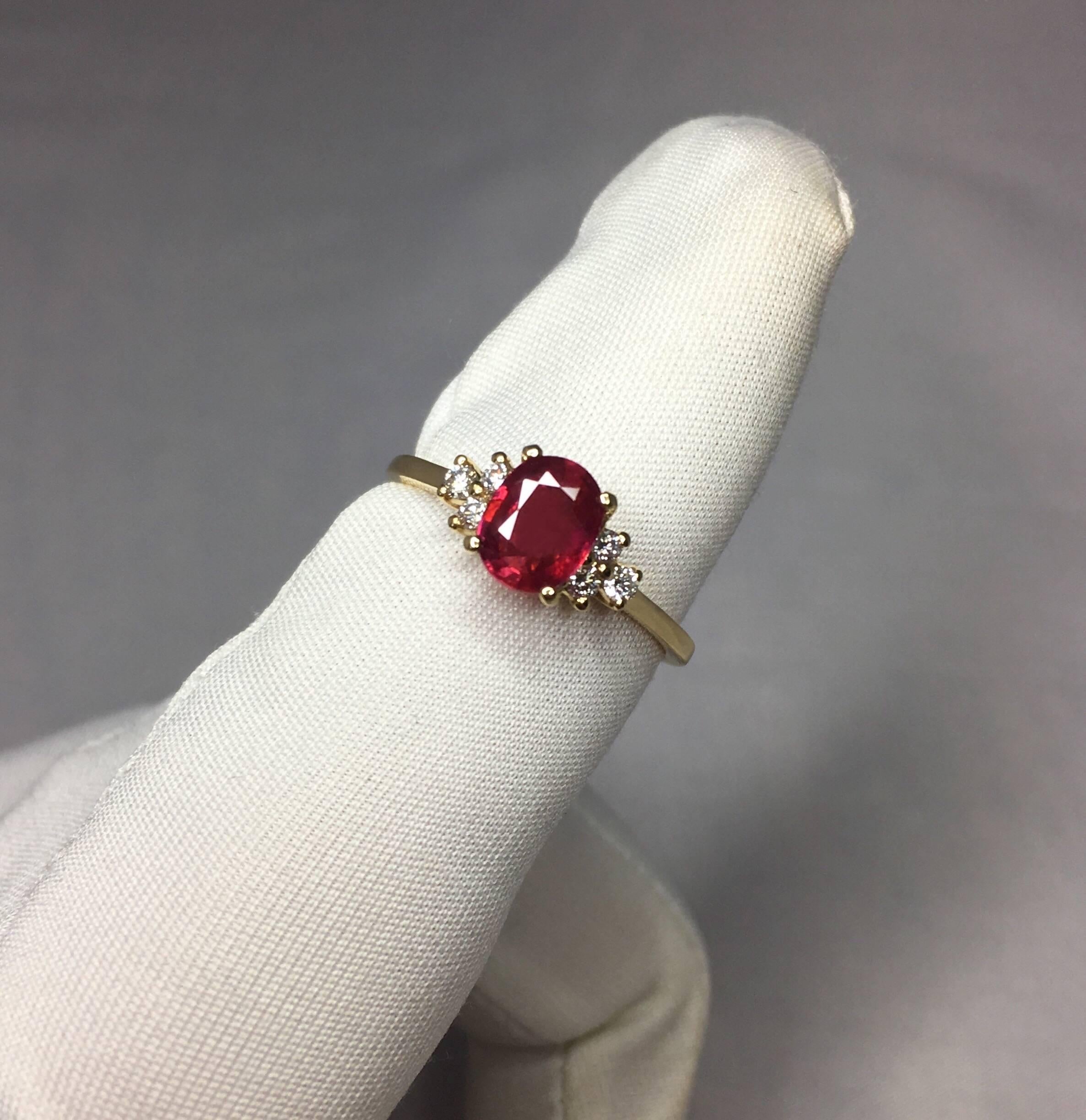 Stunning natural pinkish red ruby ring with diamond accents.

1.12 carat centre ruby with a beautiful pinkish red colour. It also has an excellent oval cut to show lots of brightness and light return.

Accented by 3 round brilliant cut diamonds each