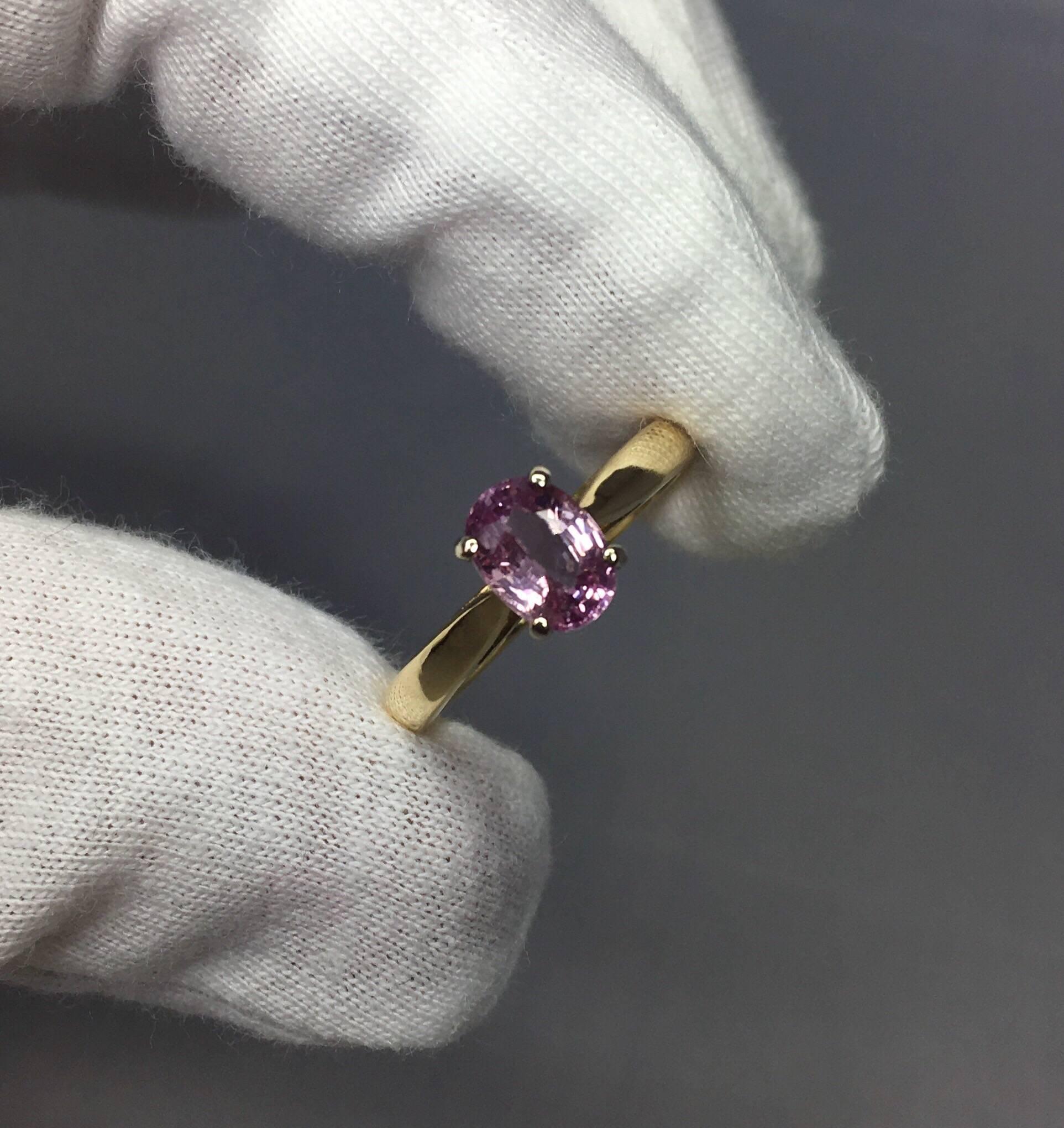 Stunning purplish pink sapphire set in a fine 18k multi-tone gold setting.
White gold head and yellow gold shank which suits this stone well.

1.37 carat sapphire with stunning vivid pink purple colour and very good clarity.

Totally untreated and