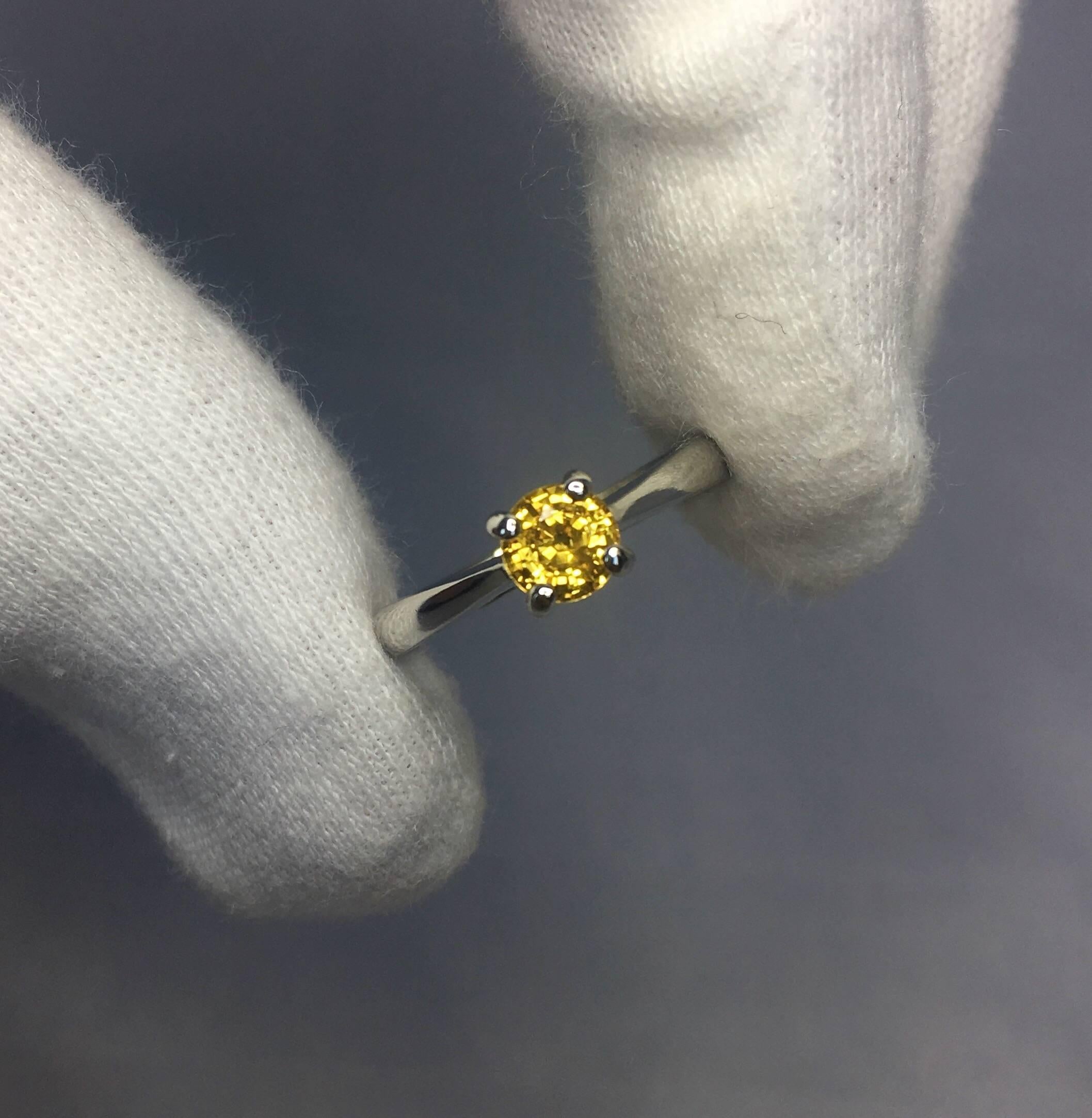 Natural vivid yellow Ceylon sapphire set in a beautiful 950 platinum setting. 

0.65 carat stone with vivid colour and superb clarity. very clean stone.

Has an excellent round brilliant cut which shows lots of sparkle and light return. Looks even