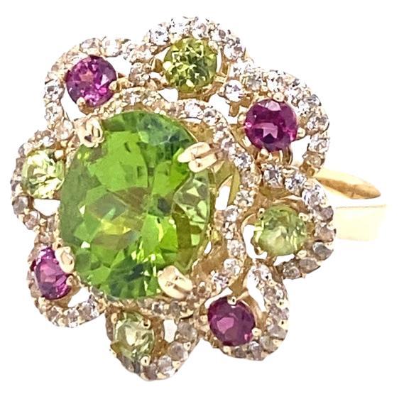 6.20 Carat Peridot Garnet White Sapphire Yellow Gold Cocktail Ring

This beautiful ring has a vibrant Peridot that weighs 3.98 carats and measures at approximately 10 mm x 12 mm. The ring is surrounded by Purple Garnets and Peridots and weigh