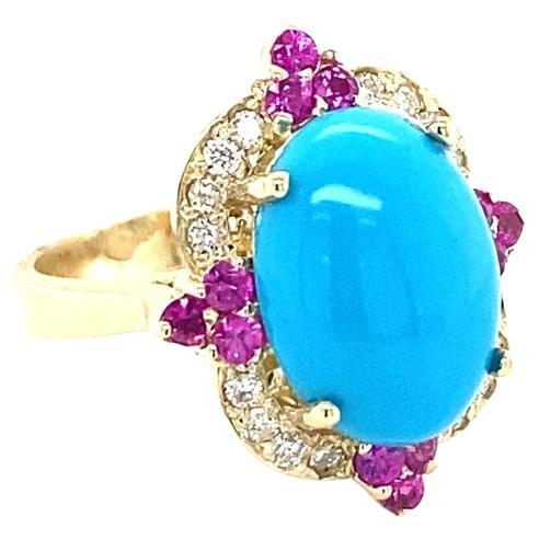 5.67 Carat Turquoise Diamond Pink Sapphire 14 Karat Yellow Gold Ring

This gorgeous Victorian inspired cocktail ring has a beautiful Oval Cut Turquoise that weighs 4.80 carats and 16 Round Cut Diamonds that weigh 0.26 carats (Clarity: SI2, Color: F)