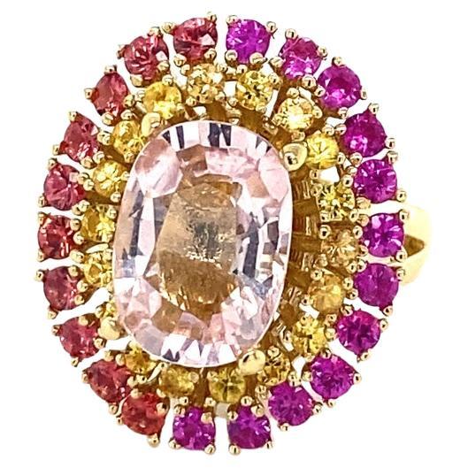 6.32 Carat Natural Pink Morganite Sapphire Rose Gold Cocktail Ring 

This ring has a 4.07 Carat Oval Cut Pink Morganite and is surrounded by 40 Round Cut Yellow, Red and Pink Sapphires that weigh 2.25 Carats The Total Carat Weight of the ring is