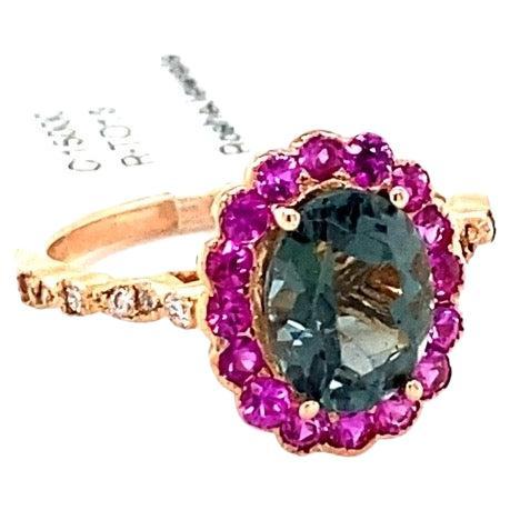 2.74 Carat Tourmaline Sapphire Diamond Rose Gold Cocktail Ring

This ring has a 1.93 carat Oval Cut Tourmaline that is set in the center of the ring and is surrounded by 16 Pink Sapphires that weigh 0.70 carats and 12 Round Cut Diamonds that weigh