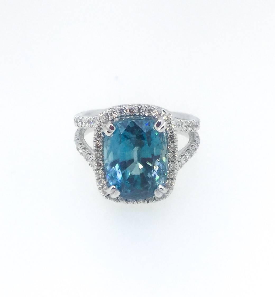 This beautiful split shank ring has a 10.57 carat Blue Zircon set in the center of the ring. A Blue Zircon is a natural stone that is mined in Vietnam. The ring is surrounded by 98 Round Brilliant Cut Diamonds that weigh 1.35 carats (Clarity: VS -
