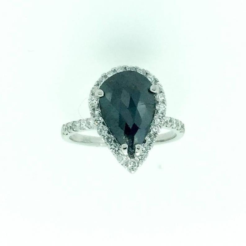 A stunner that can transcend into a unique engagement ring!! This ring is made in 14K White Gold and weighs approximately 3.2 grams. The Black Diamond is a Pear Cut and weighs 1.83 carats. The Black Diamond is a natural diamond that has been