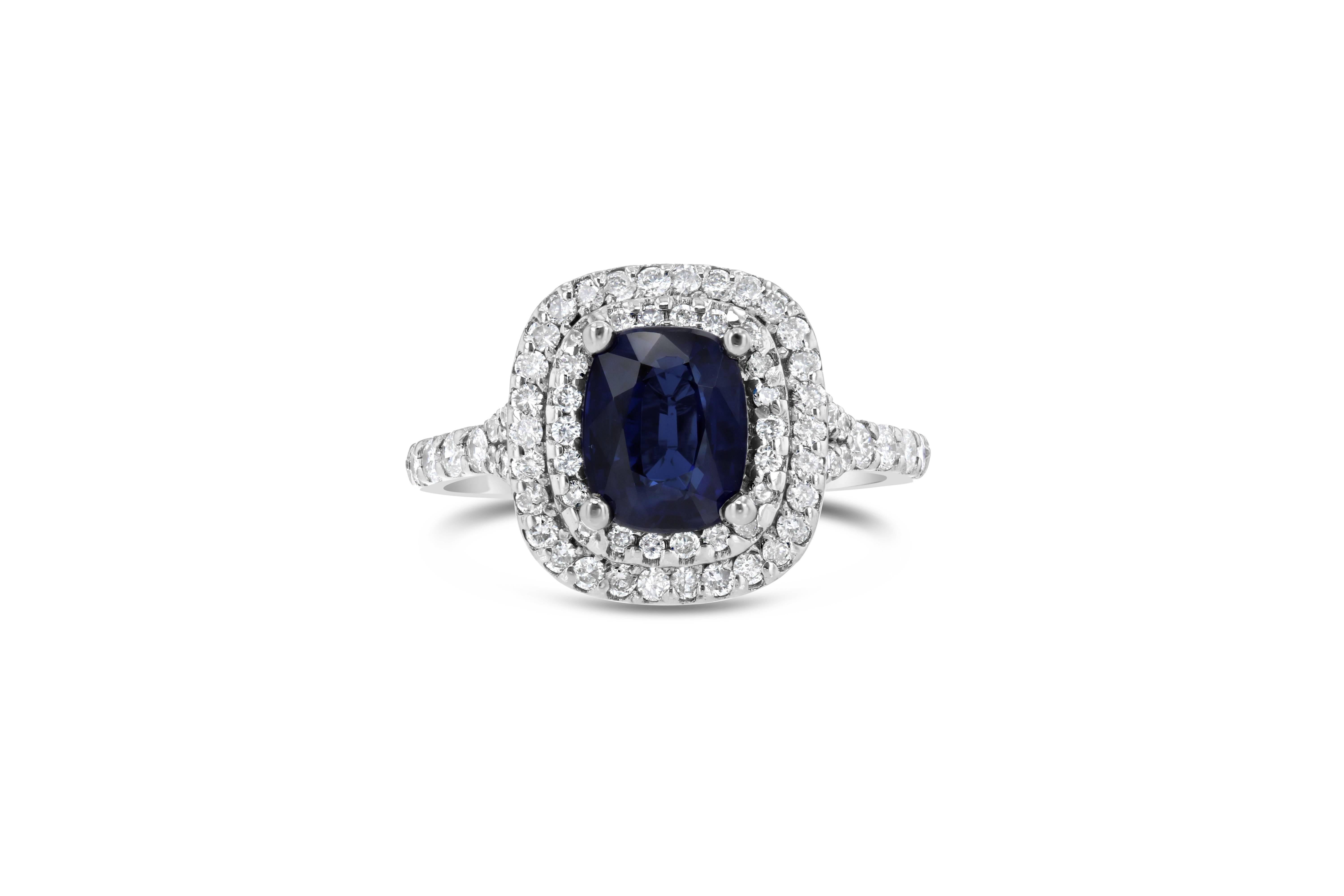 Gorgeous double halo Sapphire and Diamond ring that can easily be worn as a unique Engagement ring!  The deep blue Sapphire weighs 2.01 carat and is surrounded by 75 Round Cut Diamonds that weigh 0.65 carats.  The clarity ranges from SI1-SI2 and