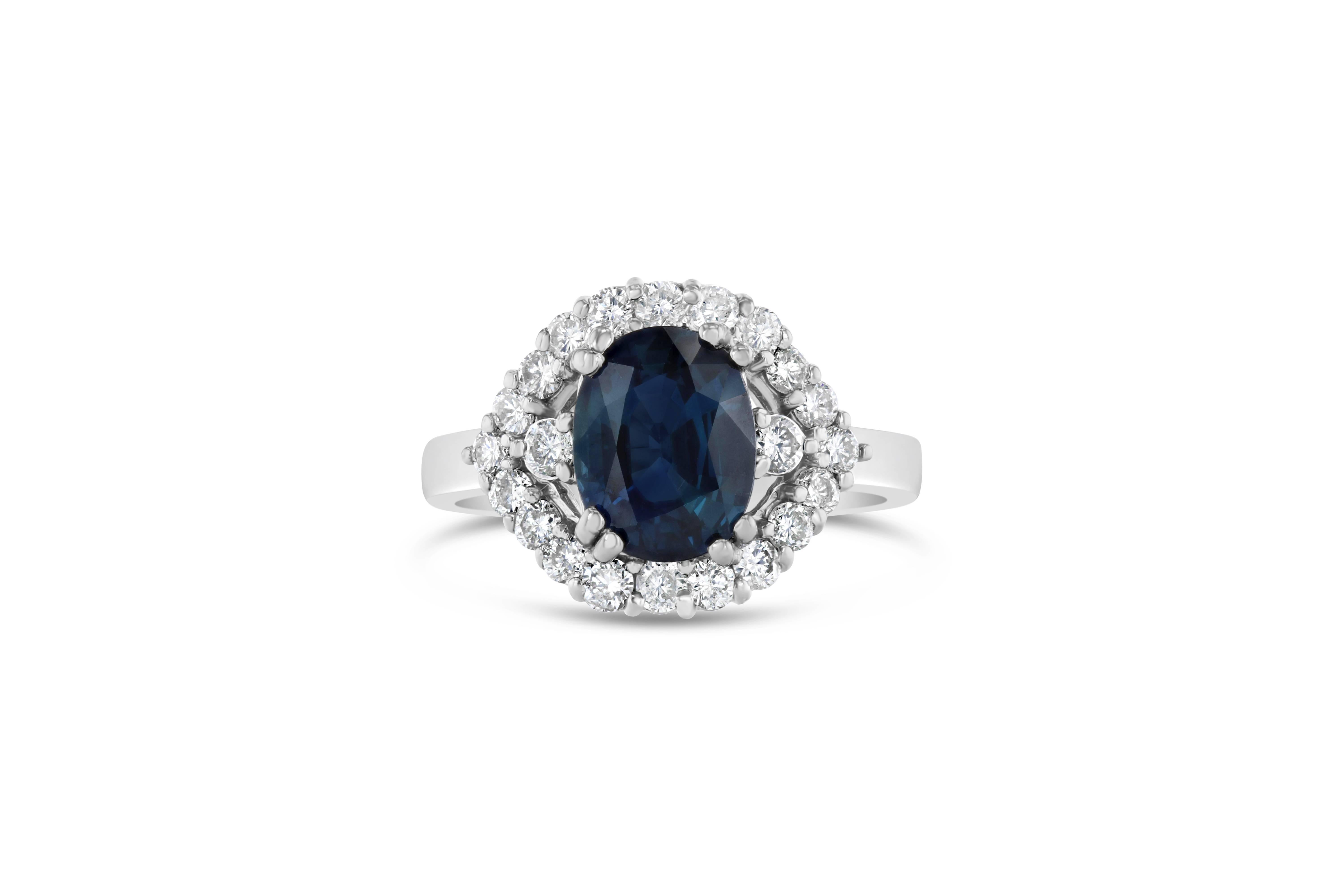 Beautiful Blue Sapphire and Diamond Cluster Ring!  This ring has a 2.67 carat Oval Cut Blue Sapphire in the center of the ring and is surrounded by 22 Round Cut Diamonds that weigh 0.73 carats.  The clarity and color is VS2/H.  This ring is casted