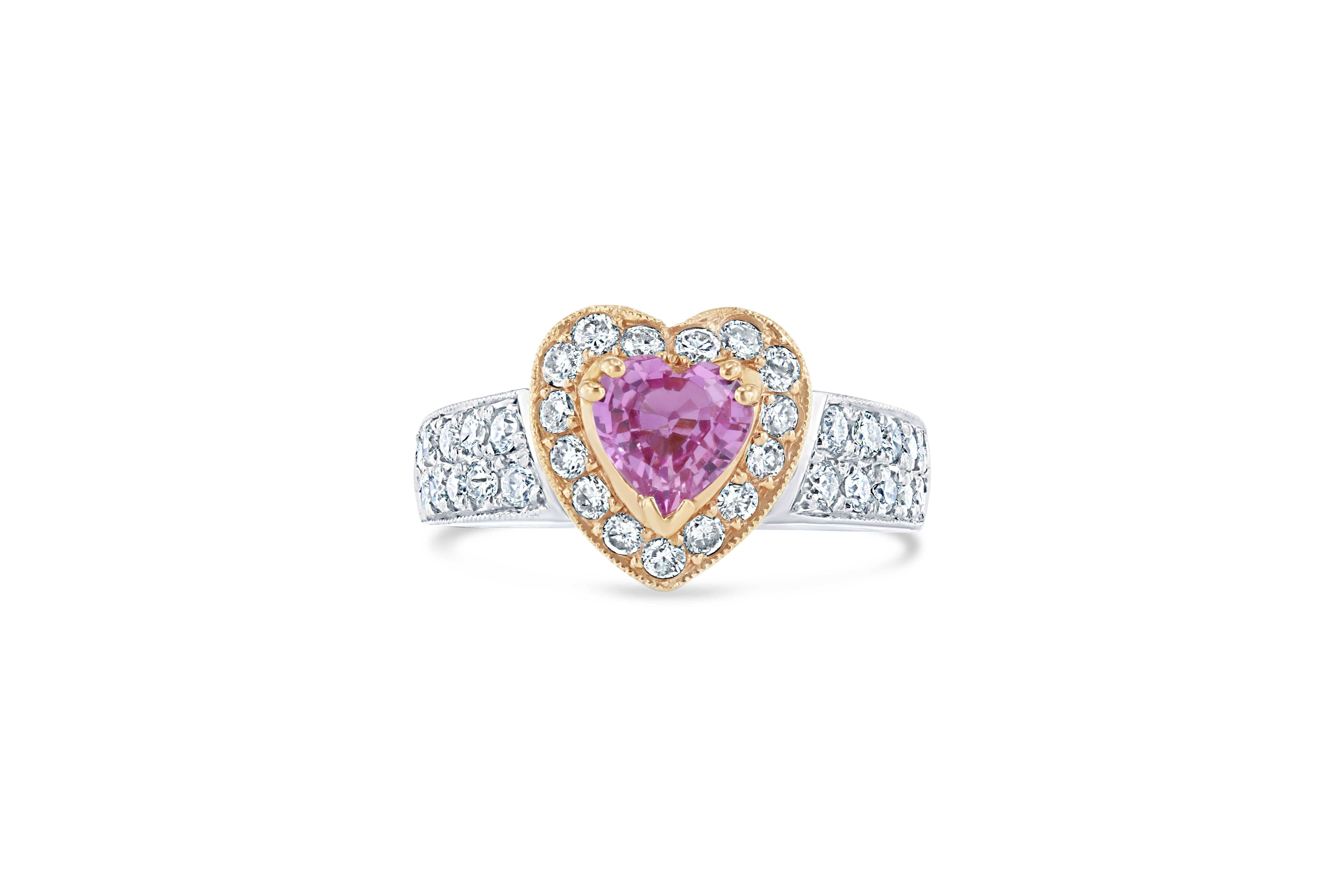 Gorgeous Heart Cut Pink Sapphire and Diamond Engagement Ring.  This ring has a 0.81 carat Heart Cut Pink Sapphire in the center of the ring and is surrounded by 35 Round Brilliant Cut Diamonds that weigh 0.71 carat. This two-tone ring is casted in