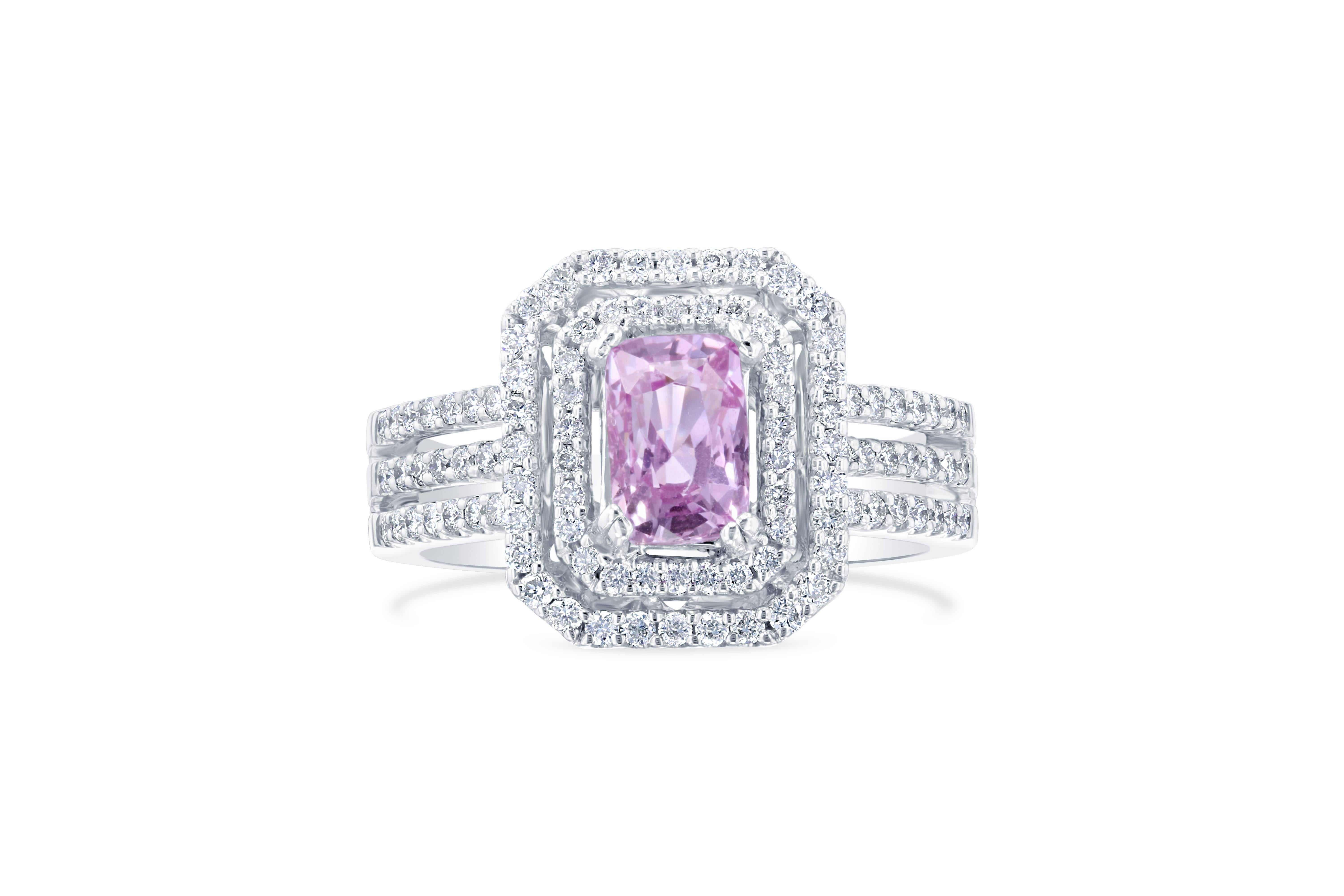 Gorgeous double halo engagement ring alternative! This ring has a Rectangular Cut 1.58 carat Pink Sapphire in the center of the ring and is surrounded by 100 Round Cut Diamonds that weigh 0.58 carat. The ring is casted in 18K White Gold that weighs