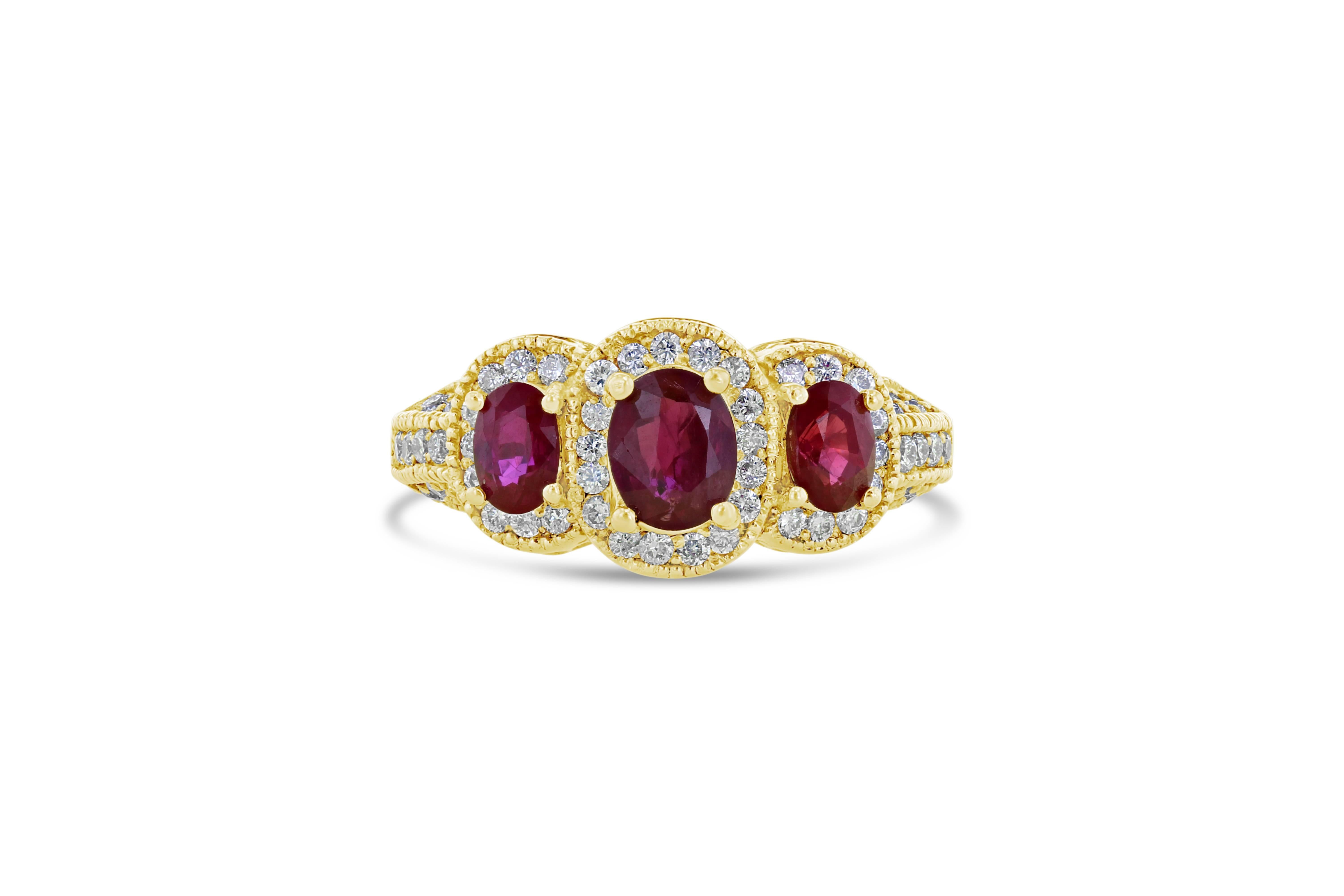 This Ruby Diamond 3 Stone Ring has an antique look but with a modern halo setting surrounding the 3 beautiful gems. The natural Burmese Rubies weigh a total of 1.70 Carats with 61 Round Cut Diamonds weighing 0.59 Carats. The ring is set in 18K