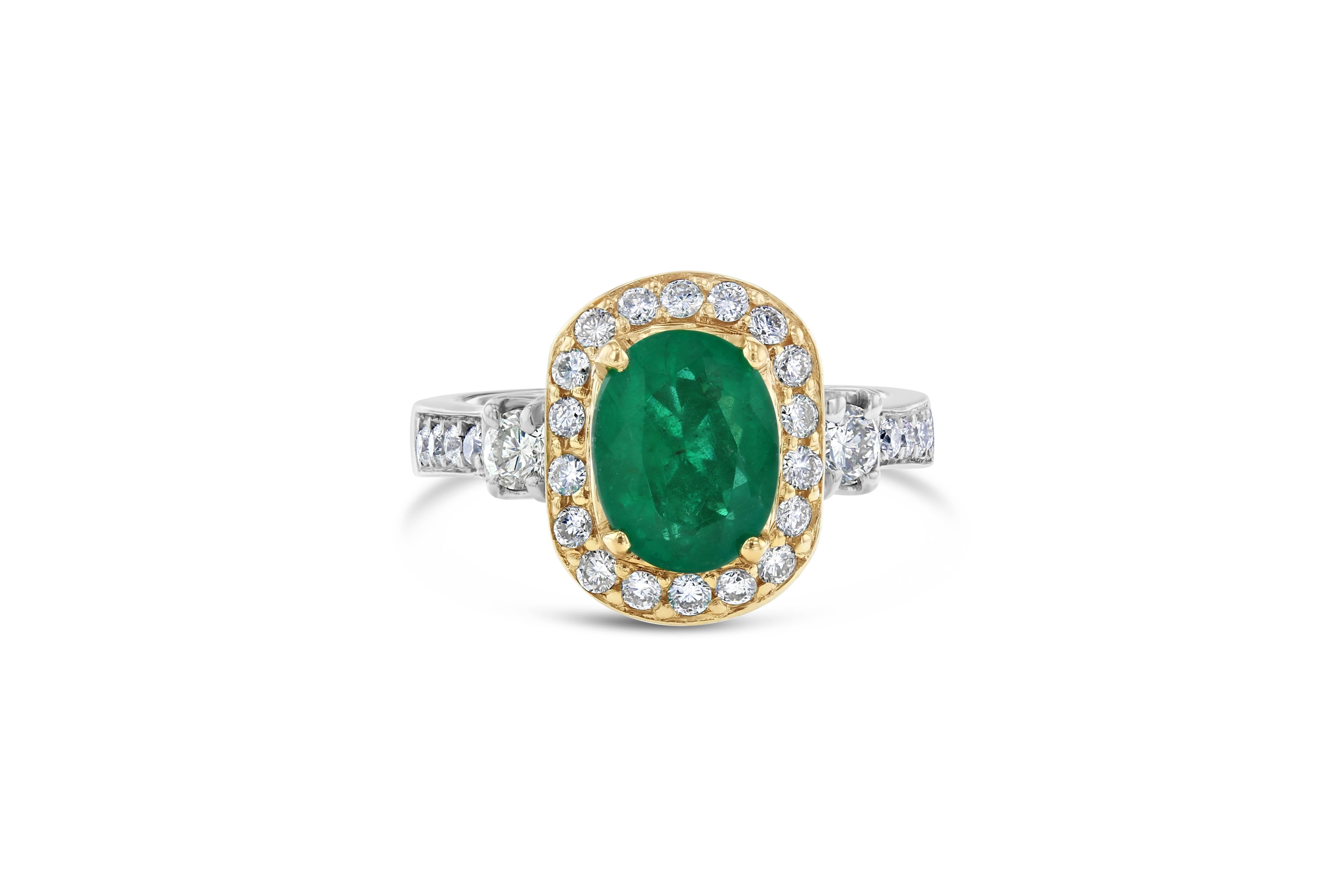 A beautiful vintage, two-tone setting holding a magnificent natural Emerald that weighs 1.68 Carats with 28 Round Cut Diamonds weighing 0.75 Carats. The two-tone setting is 14K White and Yellow Gold and is 8.1 grams. The ring is a size 7 and can be