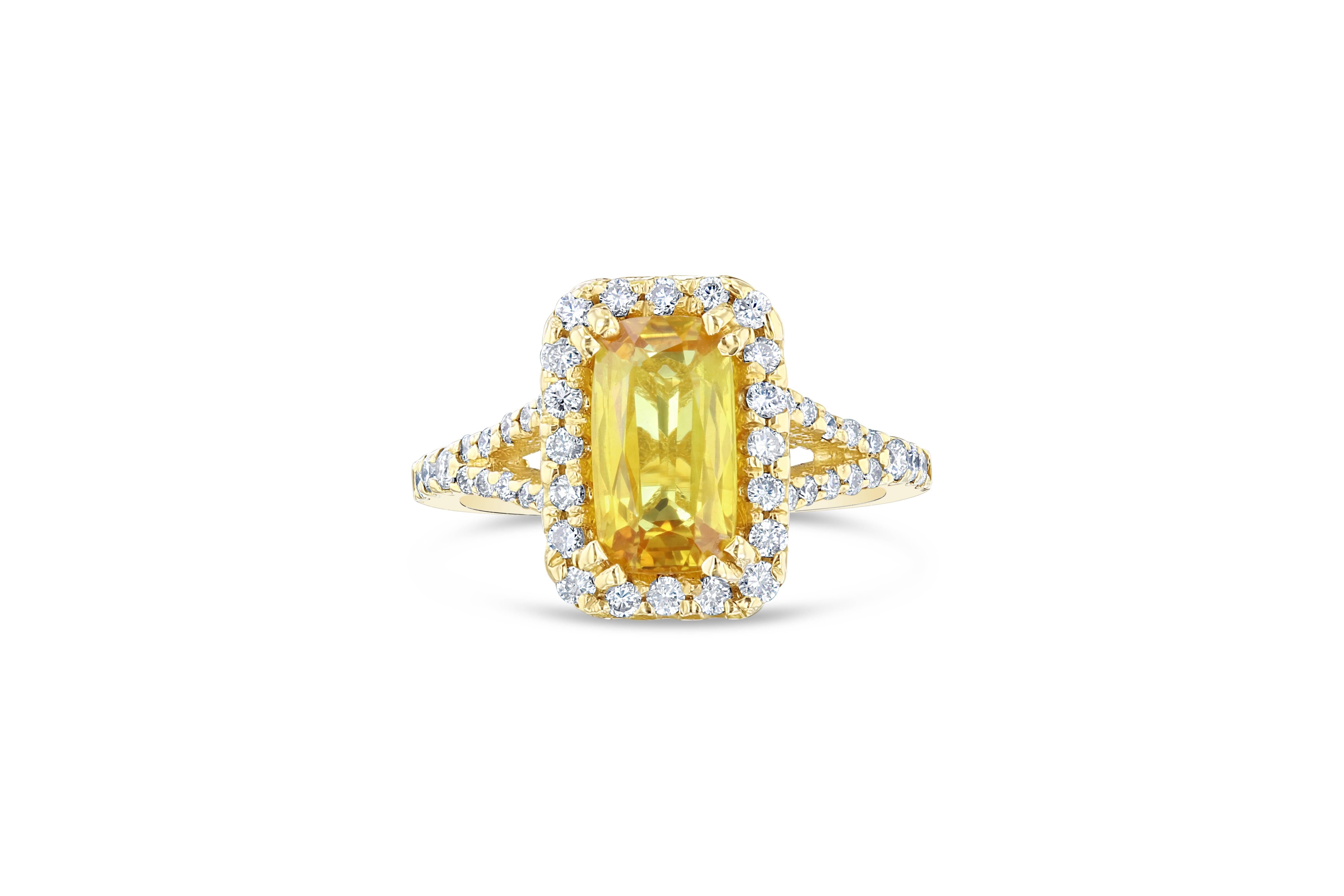 Classic Yellow Sapphire and Diamond Ring! This ring has a 2.30 carat Rectangle Cut Yellow Sapphire in the center of the ring and is surrounded by a Halo of 46 Round Cut Diamonds that weigh 0.55 carats. The clarity and color is VS2/H. This ring is