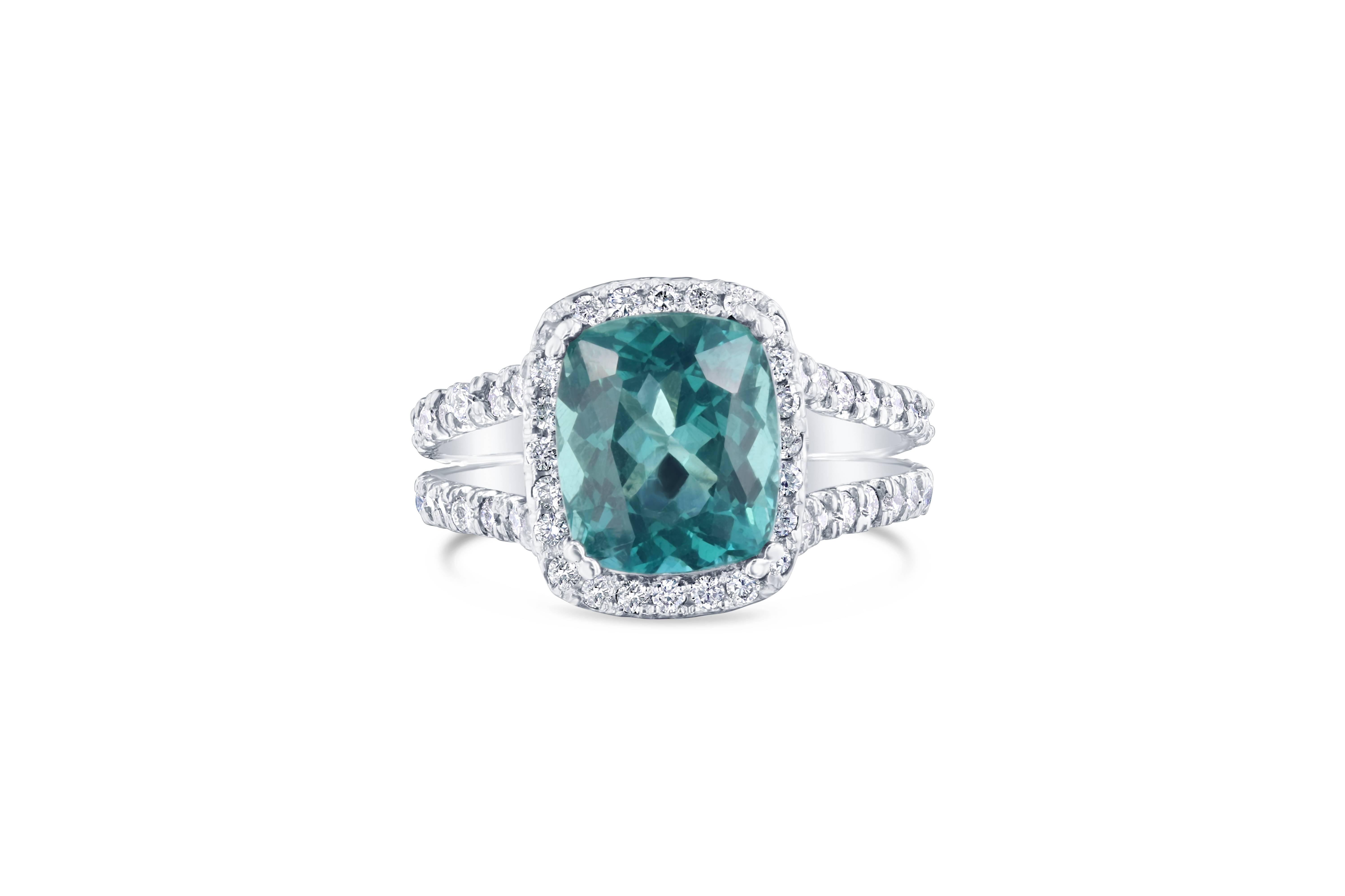 Gorgeous Blue-Green Apatite and Diamond Ring.   The stone Apatite is a natural gemstone.  This ring has a 3.65 carat rectangular cut Apatite which is surrounded by a Halo of 93 Round Cut Diamonds that weigh 1.02 carat.  The clarity and color of the