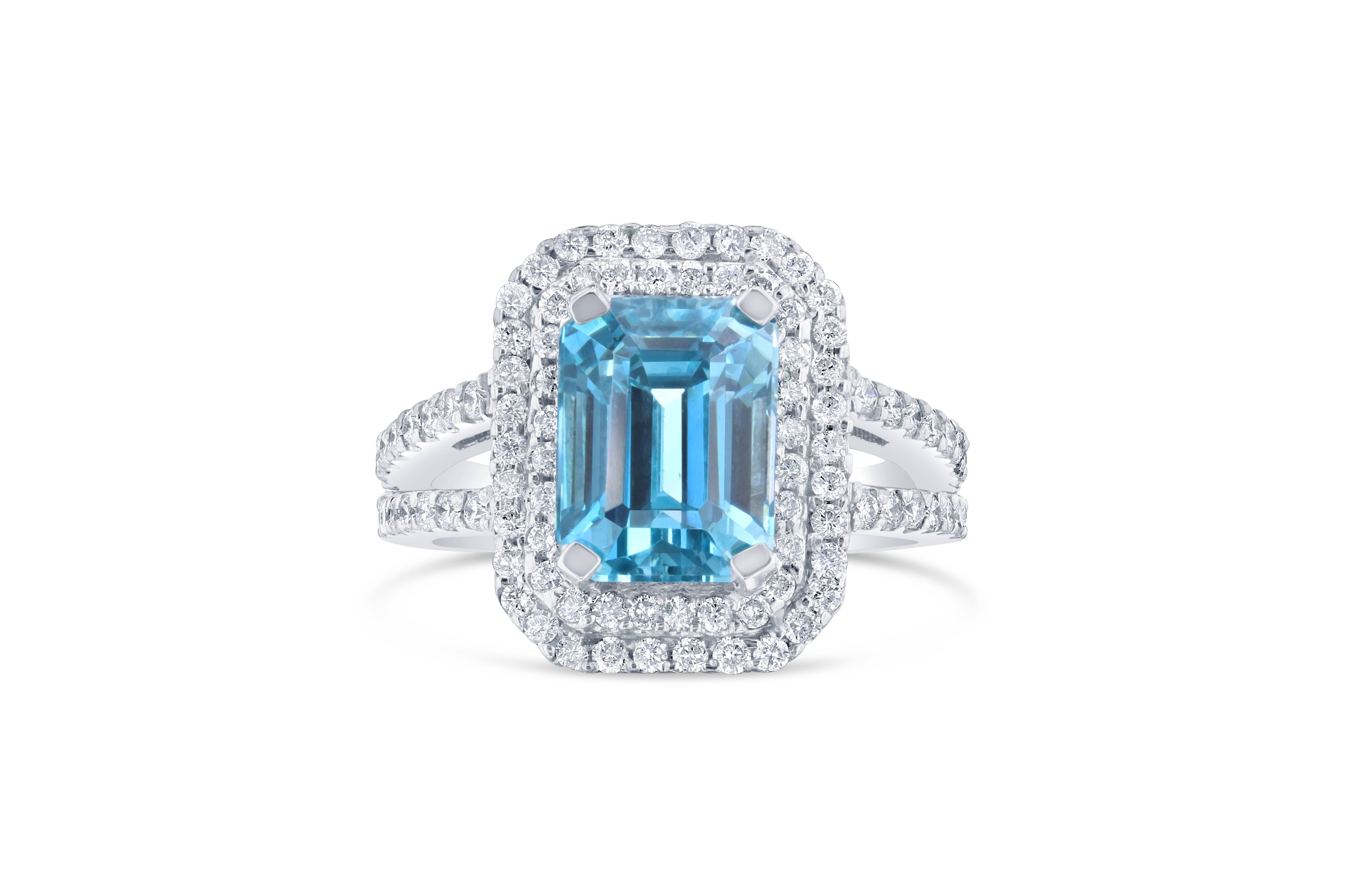 This beautiful split shank ring has a 7.58 carat Blue Zircon set in the center of the ring. A Blue Zircon is a natural stone that is mined in Vietnam. The ring has a double Halo of 86 Round Brilliant Cut Diamonds that weigh 1.07 carats. (Clarity: VS