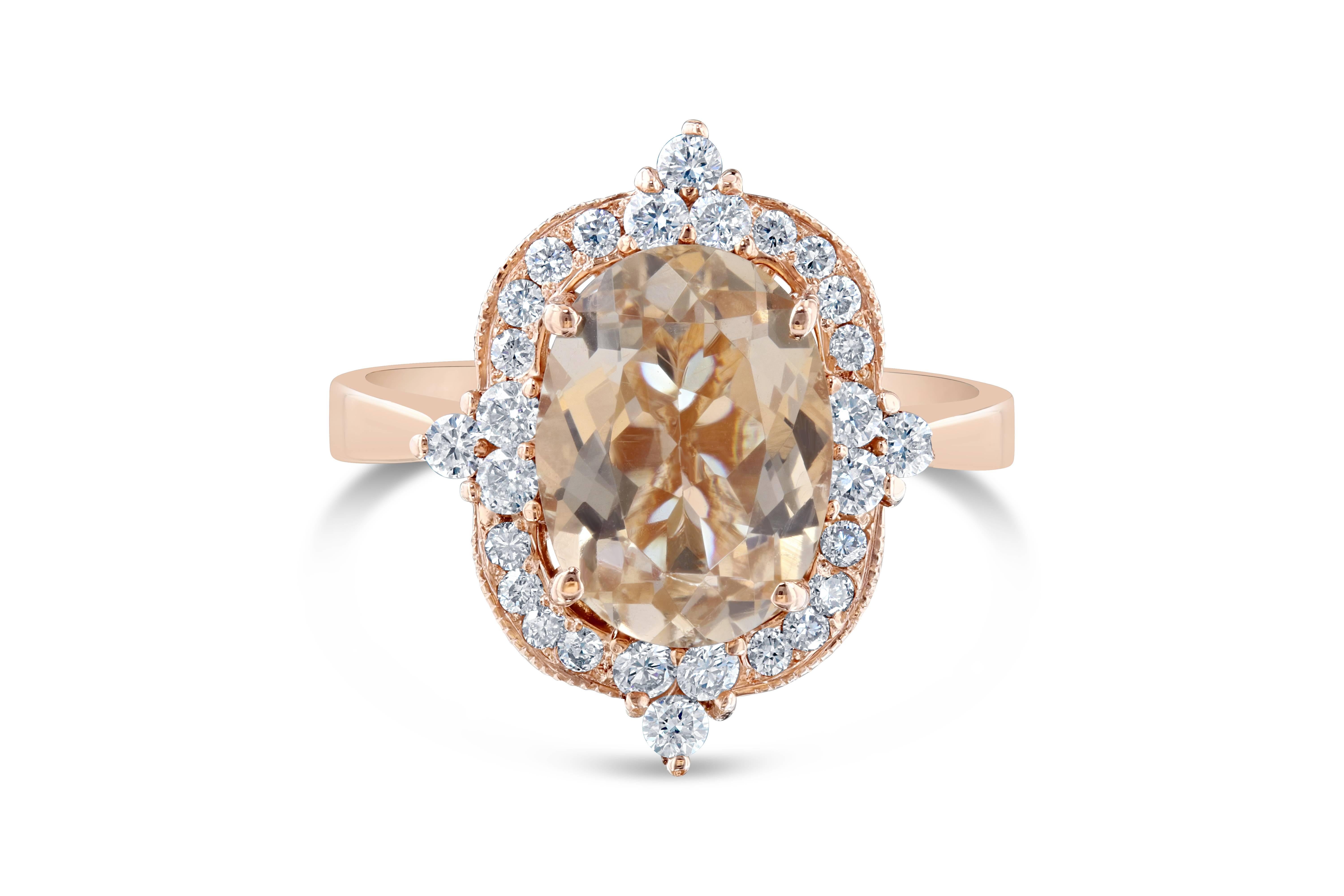 This ring has a 2.57 carat Oval Cut Morganite in the center of the ring and is surrounded by 28 Round Brilliant Cut Diamonds that weigh 0.44 carats (Clarity: VS2 and Color: H). The ring is casted in 14K Rose gold and weighs approximately 4.9 grams..