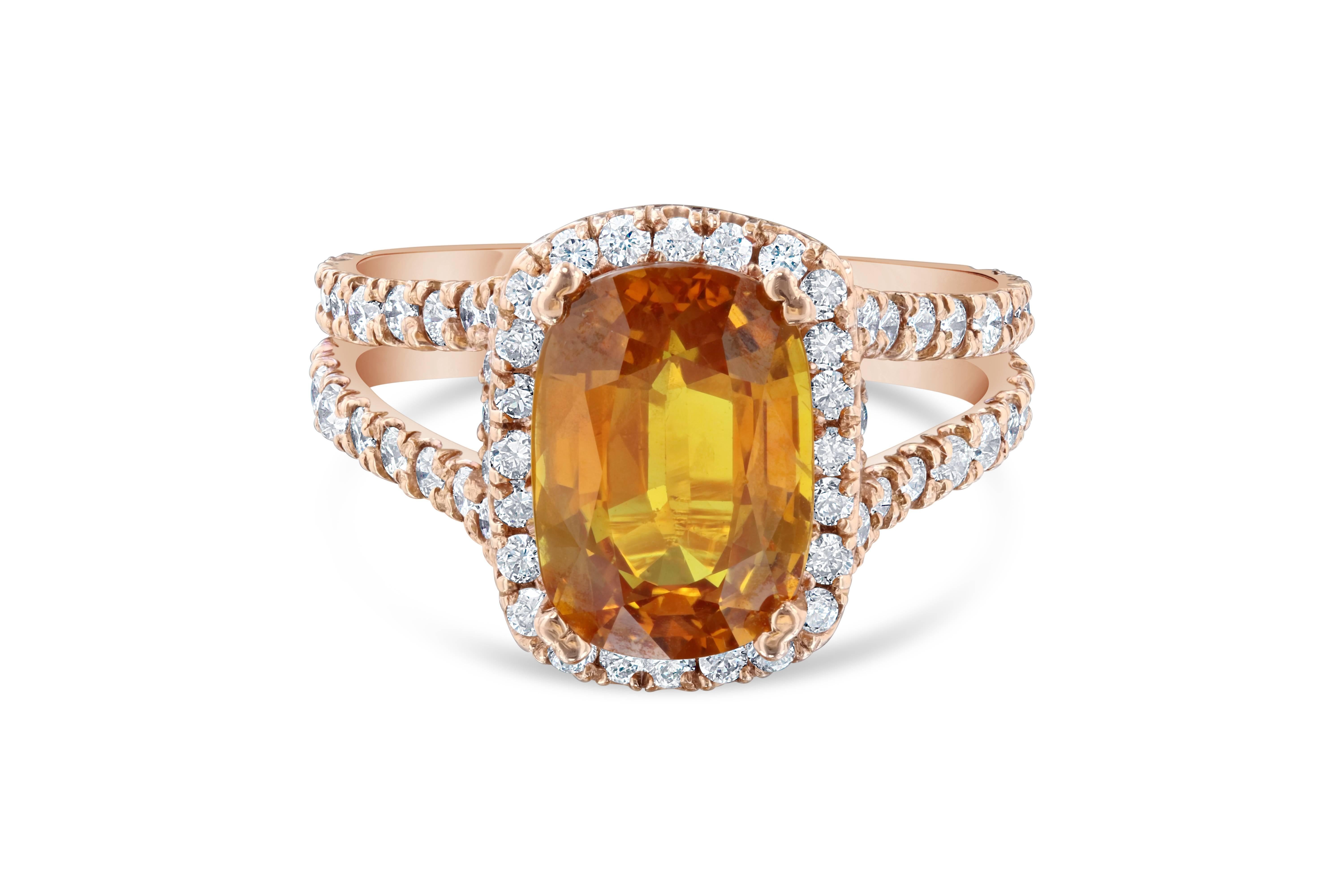 Stunning Orange Sapphire and Diamond ring made in a 14K Rose Gold Split Shank setting.  The ring has a 4.45 carat Orange Sapphire which is surrounded by a Halo of 92 Round Cut Diamonds that weigh 1.35 carats.  The ring size is 7.5 and can be