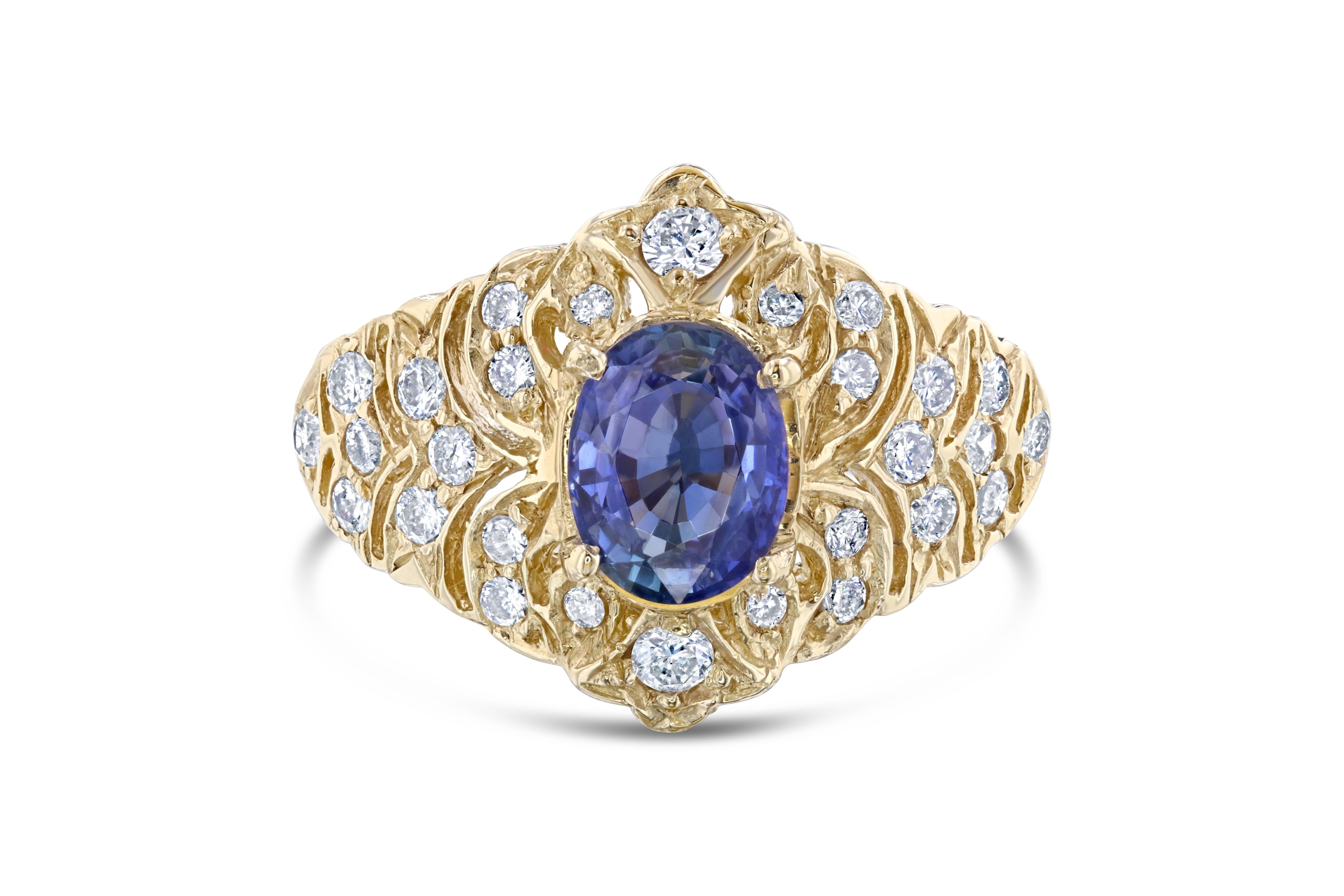 This unique ring is an art-deco inspired ring. It's beauty derives from the brilliant Blue Sapphire that weighs 1.58 Carats and has a cluster of 28 Round Cut Diamonds weighing 0.57 Carats. The total carat weight is 2.15 Carats. It is set in 14K