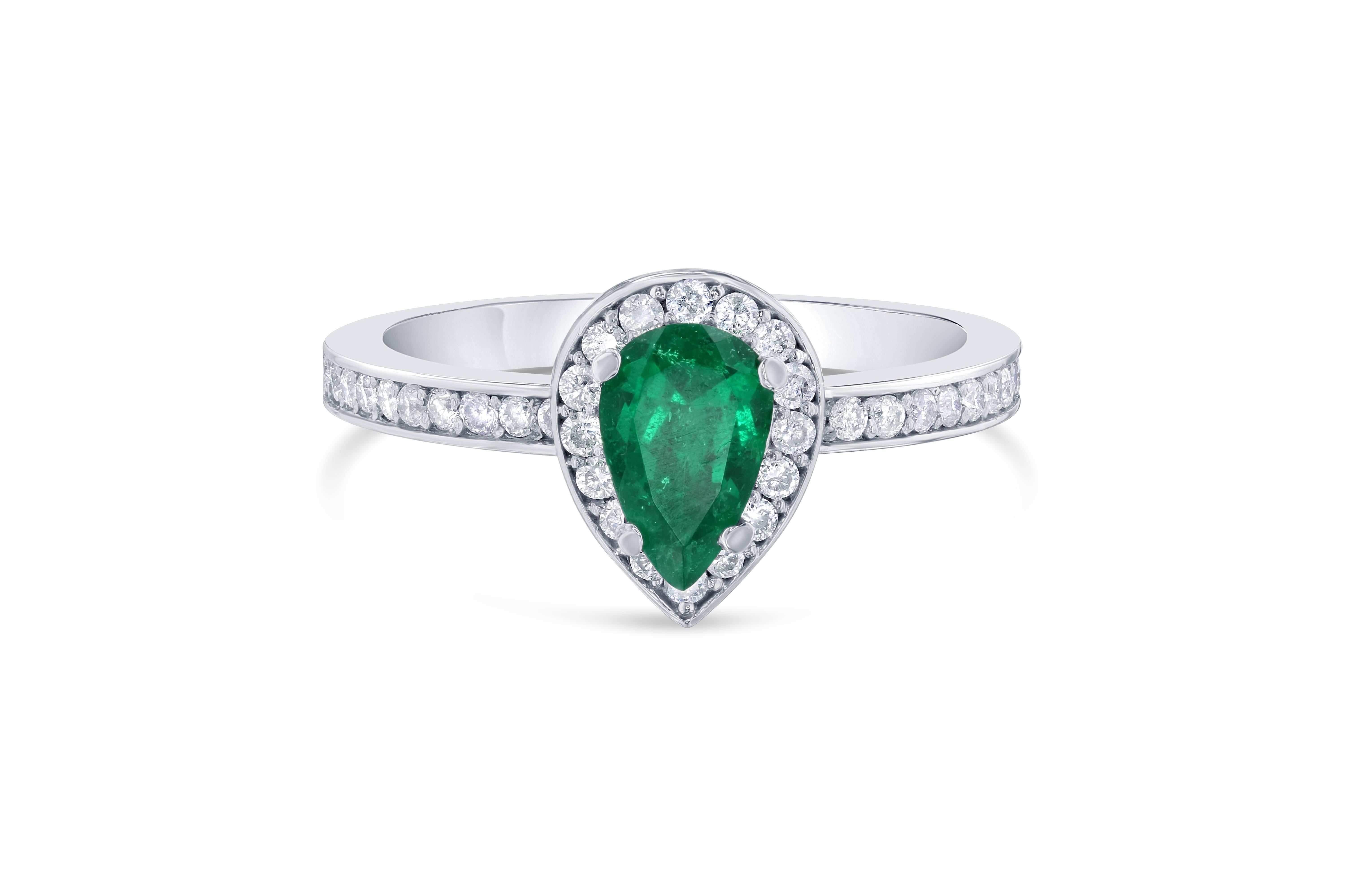 Beautiful, Stunning and Unique! This Pear Cut Emerald Ring will be a gorgeous ring to wear everyday! 
The Emerald is 0.56 Carats and is surrounded by a halo of 37 Round Cut Diamonds weighing 0.20 Carats. The total carat weight of the ring is 0.76