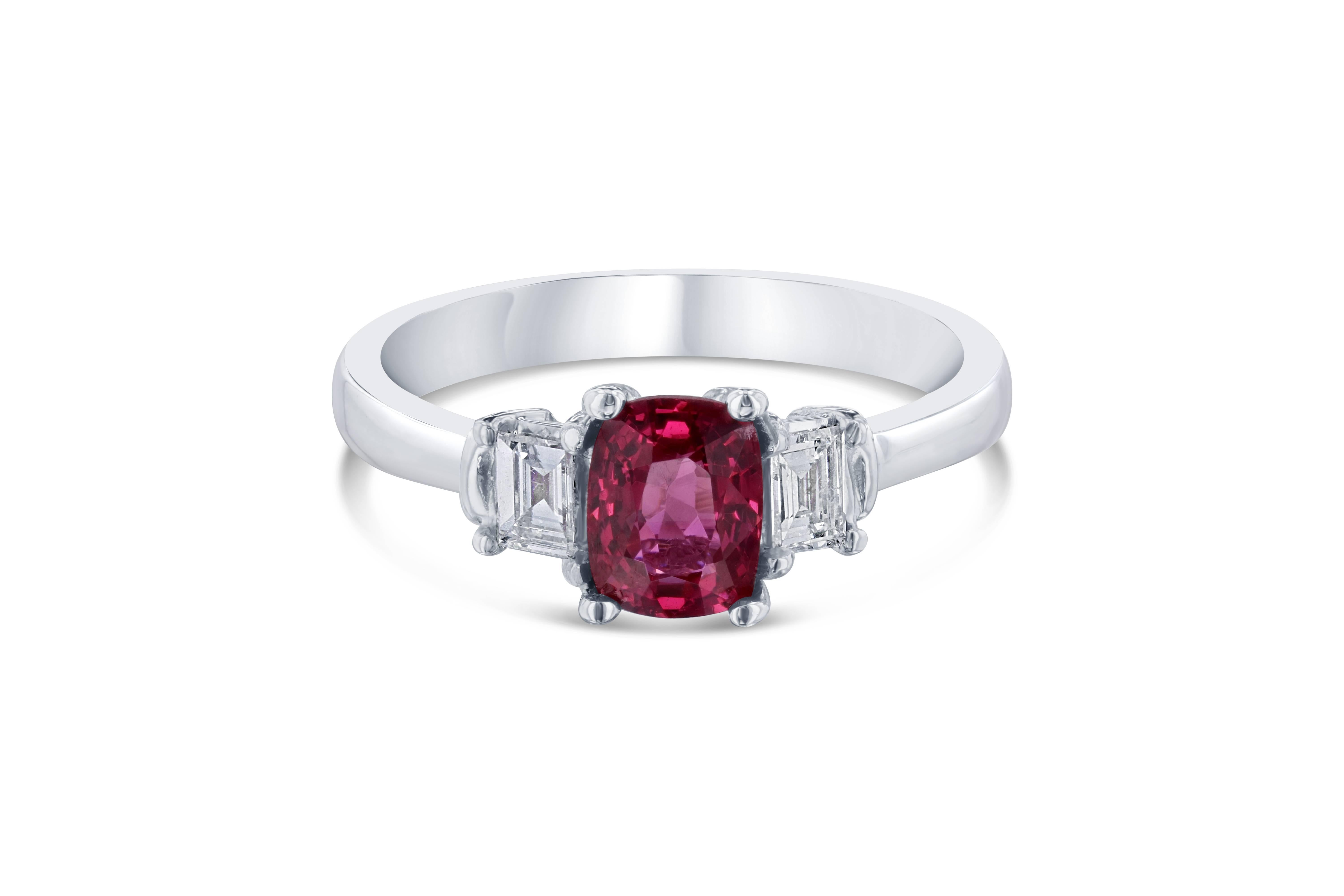 This non traditional 3 stone ring is a gorgeous Spinel ring signifying a past, colorful present and future! 

The center Spinel is 1.05 Carats with 2 Baguette Cut Diamonds on the sides weighing 0.24 Carats. The total carat weight of the ring is 1.29