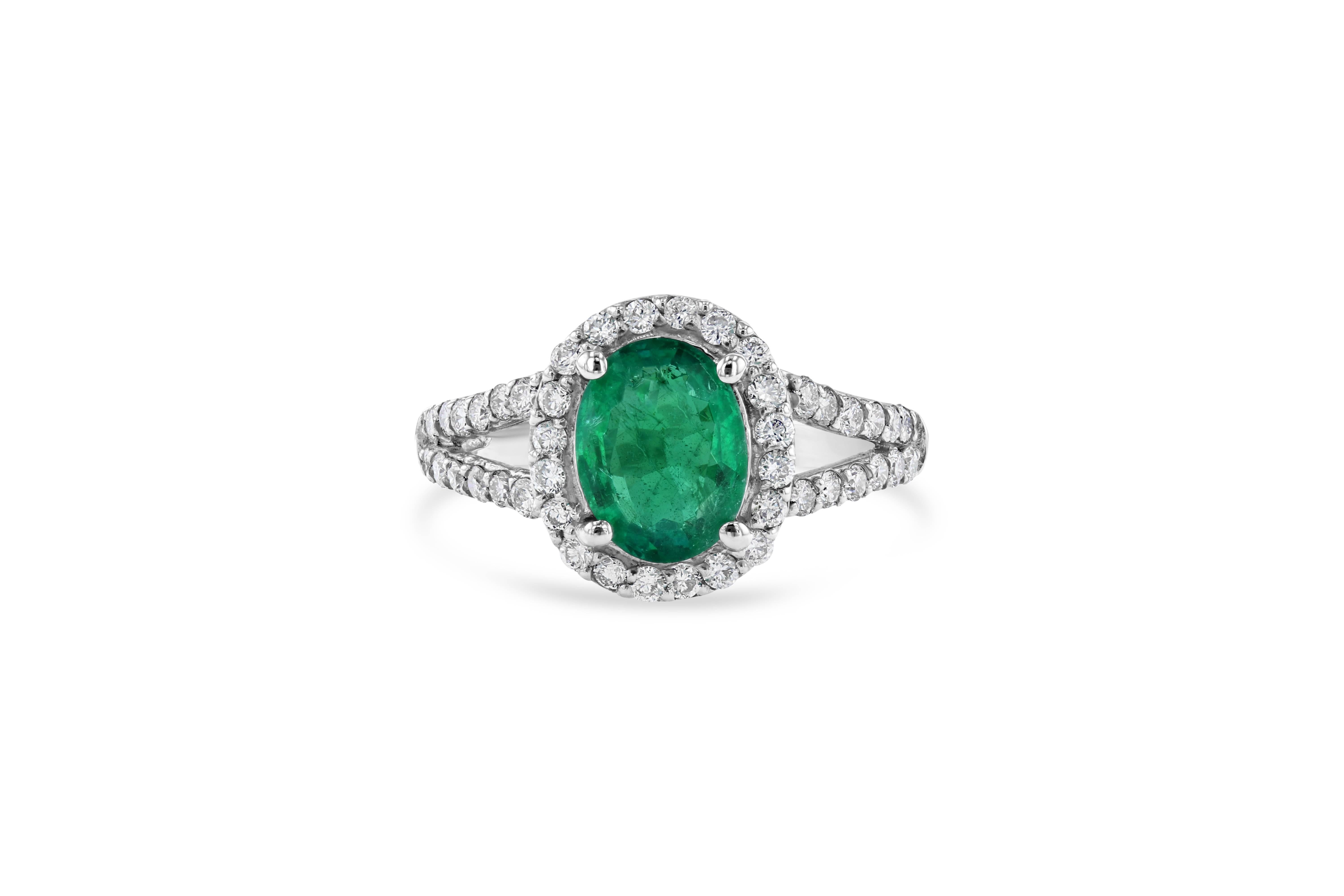 Beautiful Emerald Diamond ring with an eye catching Halo! A unique way to propose and add color to your life! 

The oval cut Emerald is 1.80 Carats surrounded by 48 Round Cut Diamonds at 0.75 Carats. The Clarity and Color of the Diamonds are VS-H.