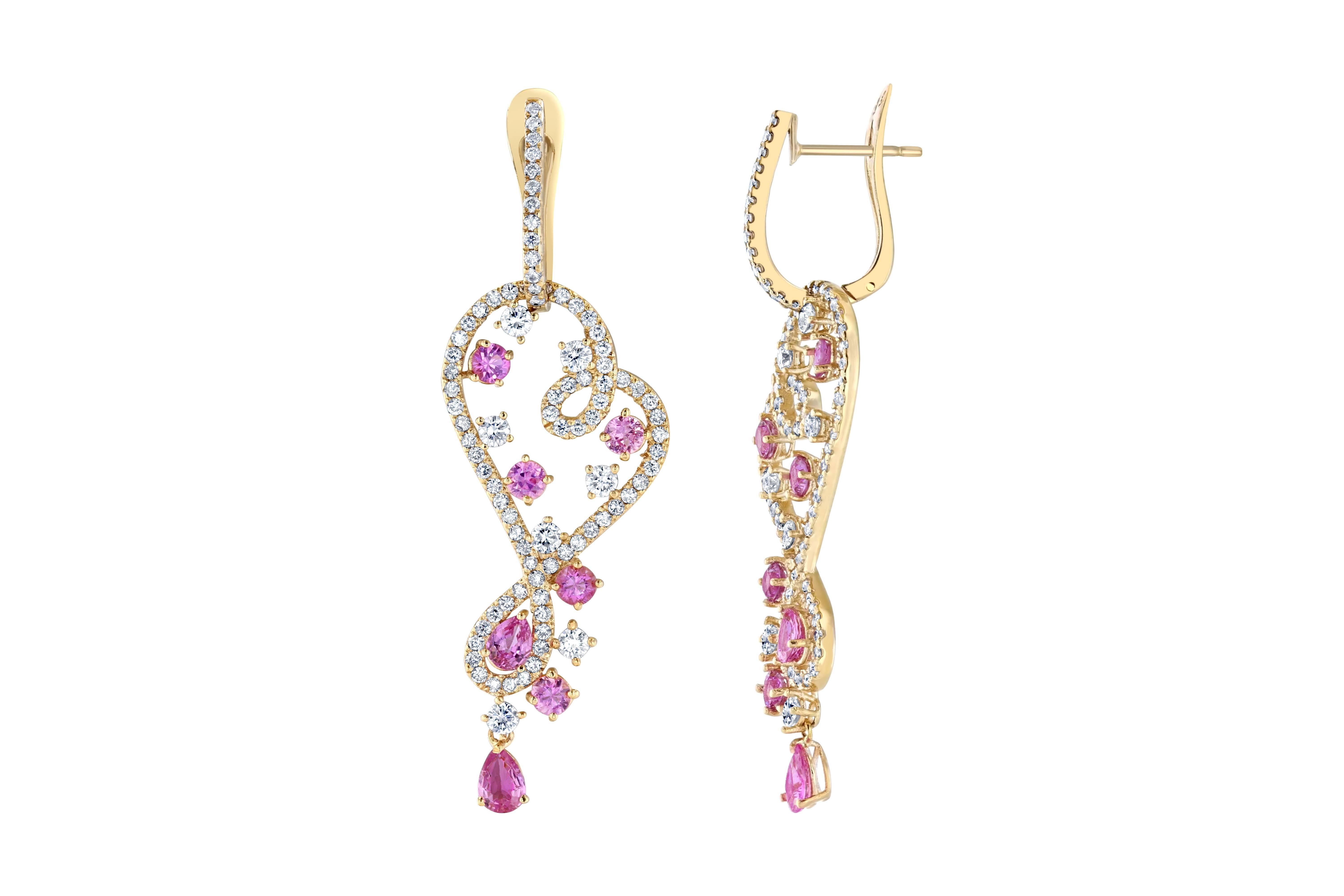 Pretty in Pink! The beautiful earrings have 14 Pink Sapphires that weigh 3.52 carats and are surrounded by 174 Round Cut Diamonds that weigh 2.98 carats.  The earrings are approximately 2.5 inches long.   They are casted in 14K yellow gold and weigh