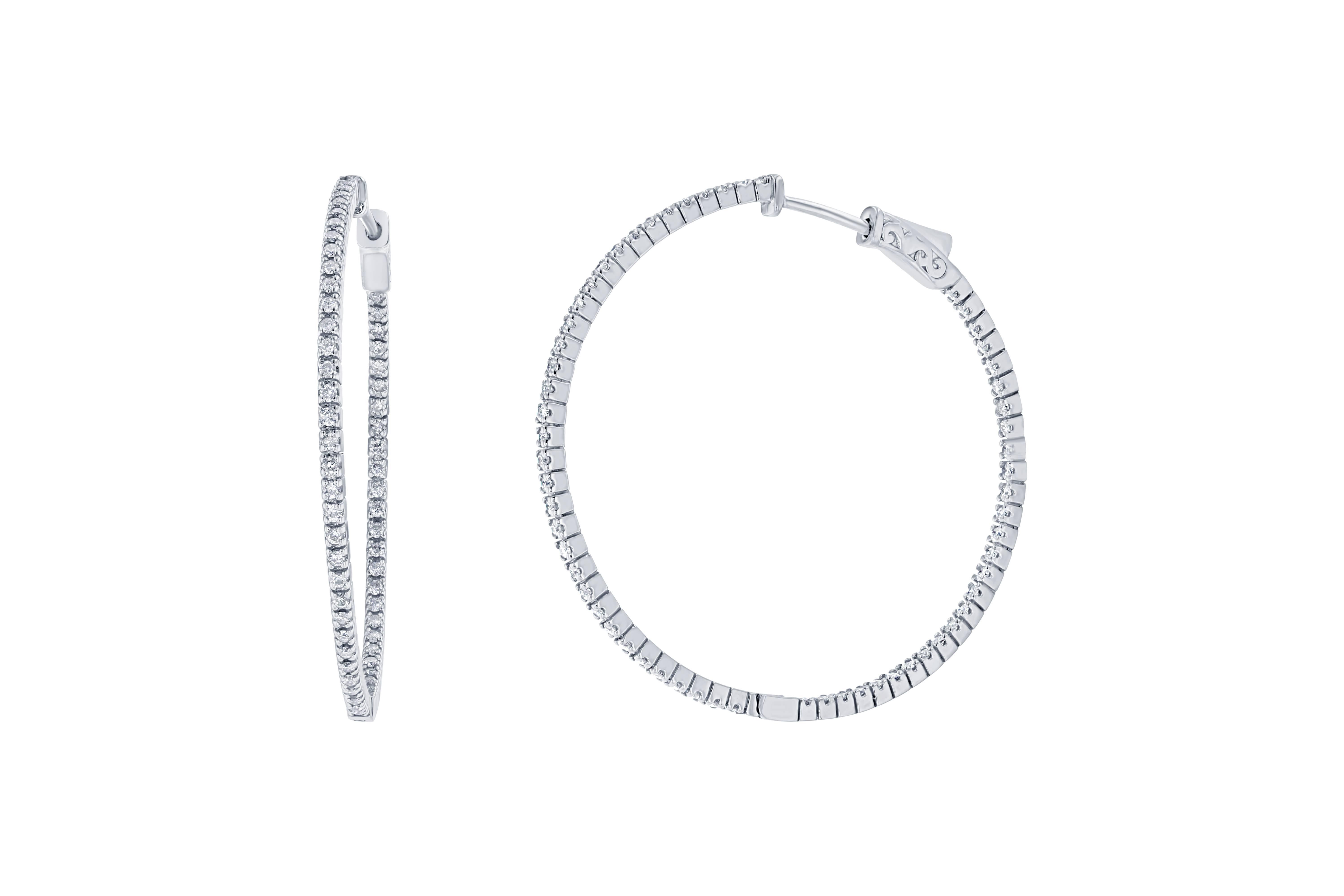 These stunning diamond hoops have diamonds set inside and out to give the piece symmetry and sparkle from all angles.  There are 124 Round Cut Diamonds that weigh 1.07 carats and they are made in 14K White Gold and weigh approximately 6.8 grams. 