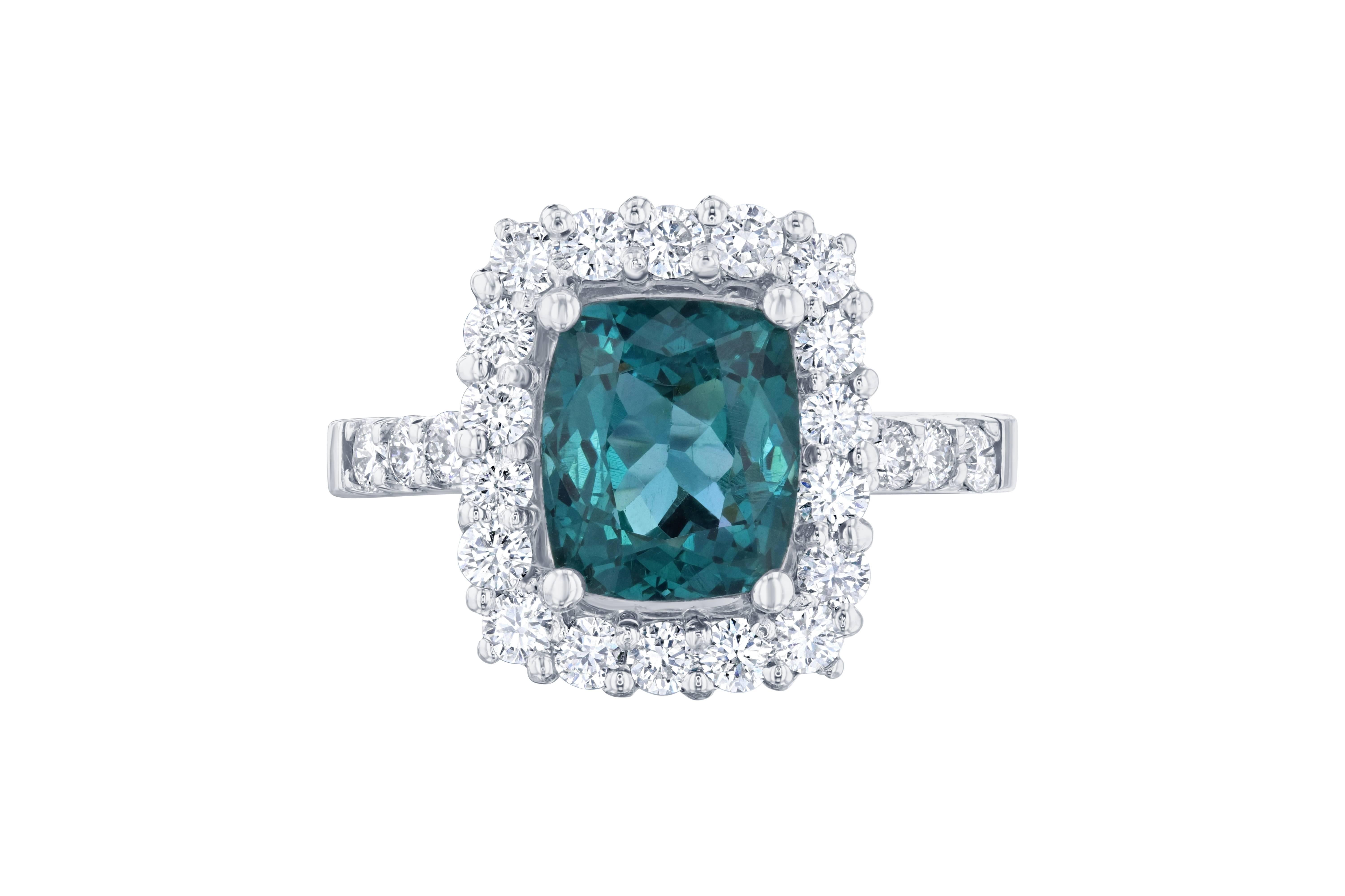 Gorgeous Halo Apatite and Diamond Ring. This ring has a 2.63 carat Apatite in the center of the ring and is surrounded by a halo of 24 Round Cut Diamonds that weigh 0.90 carat. The total carat weight of the ring is 3.53 carats.  

The ring is made