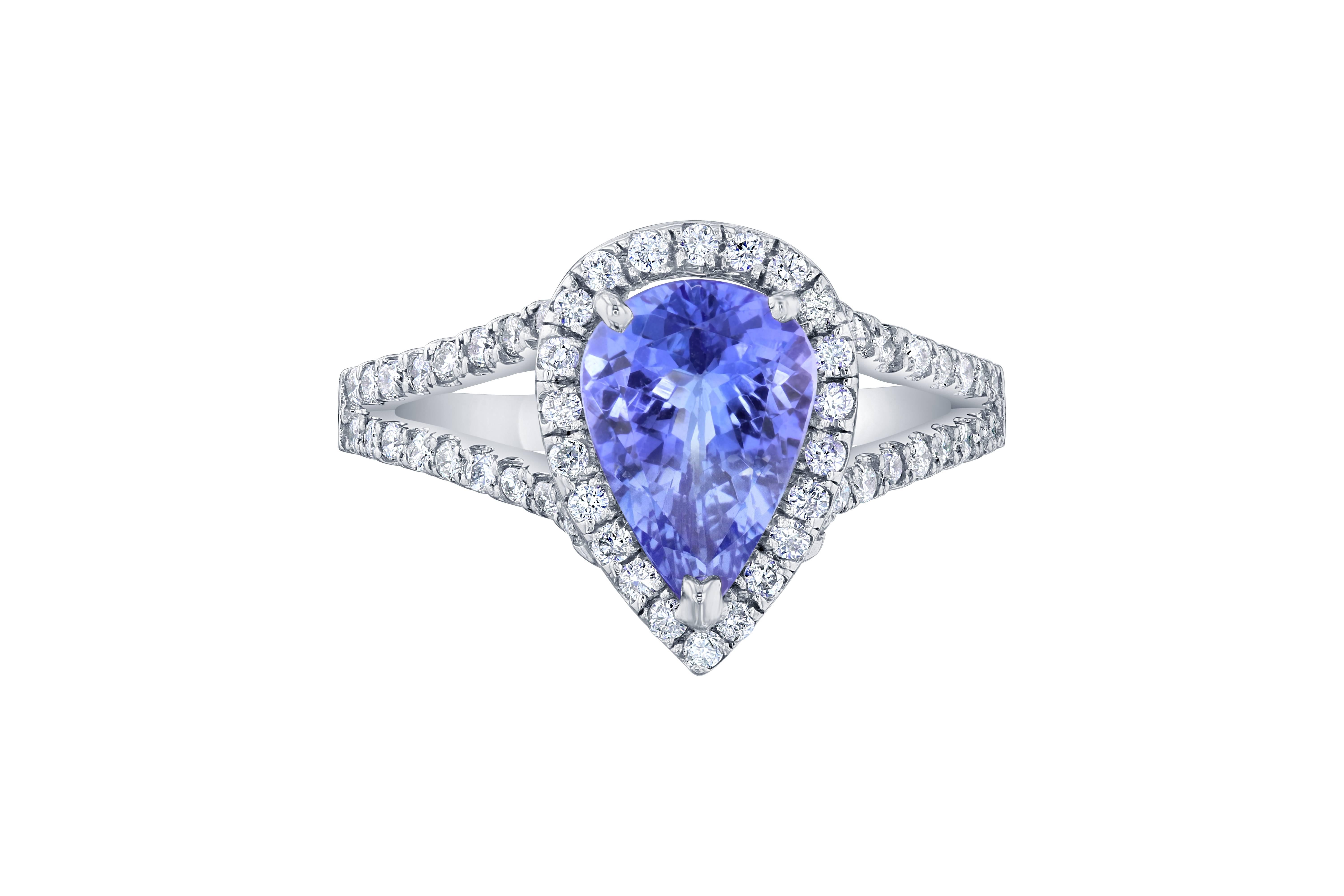 A gorgeous Tanzanite and Diamond ring set in a split shank 14K white gold setting and is approximately 5.3 grams.  The Tanzanite is a Pear cut stone that weighs 1.59 carats.  The ring is surrounded by a halo of 66 Round Brilliant Cut diamonds that