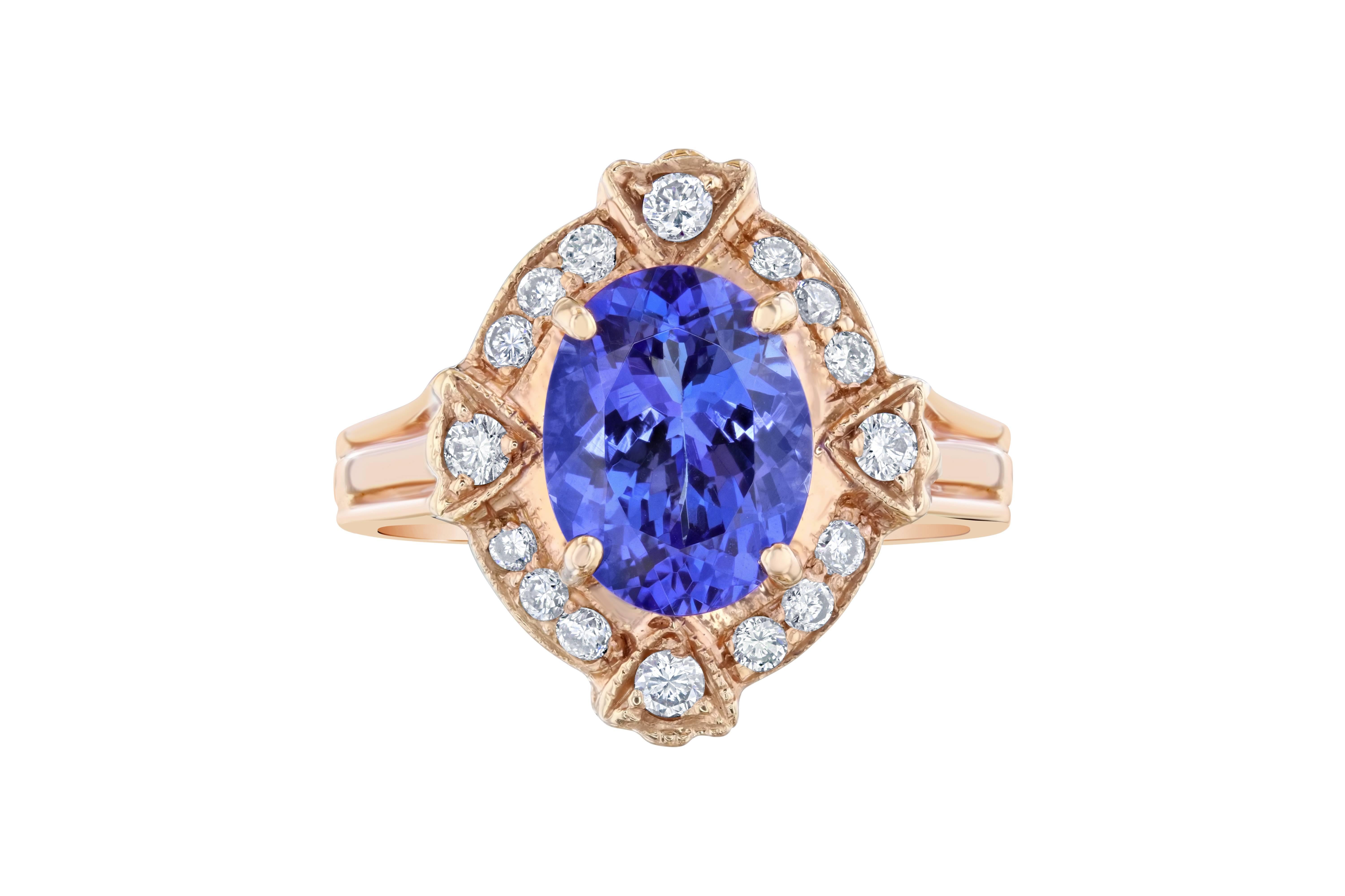 An Art-Deco inspired Tanzanite and Diamond ring set in a 14K Rose Gold Setting. The Tanzanite is an Oval cut stone that weighs 2.59 carats. The ring is surrounded by 16 Round Cut Diamonds that weigh 0.36 Carats. The Total Carat Weight of this ring