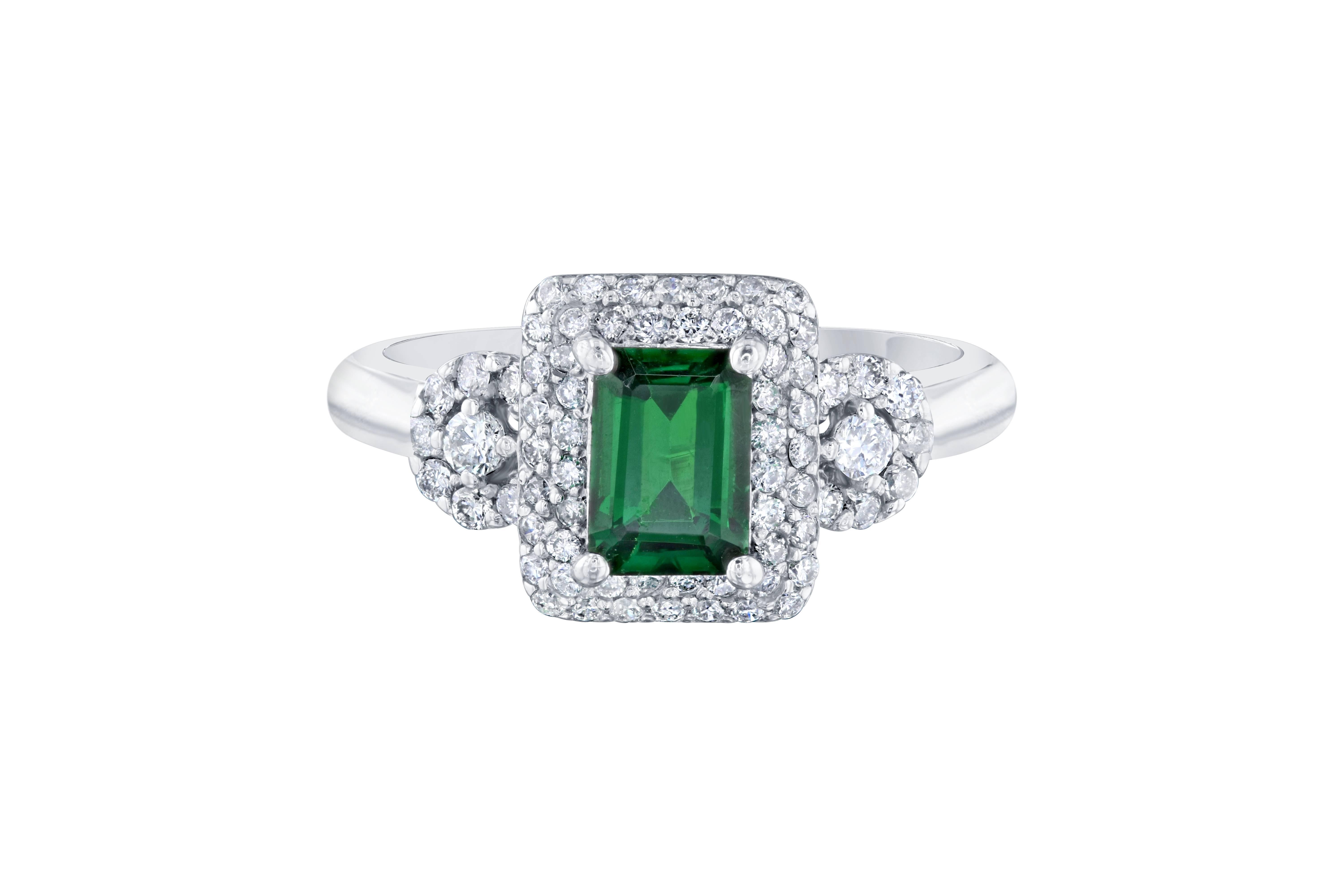 Dainty and unique setting that can compliment anyone!  This ring can easily transform into an engagement ring for the woman who wants to dip into something new and fresh.   This ring has a  rectangular cut Tsavorite which weighs 1.05 carats and is
