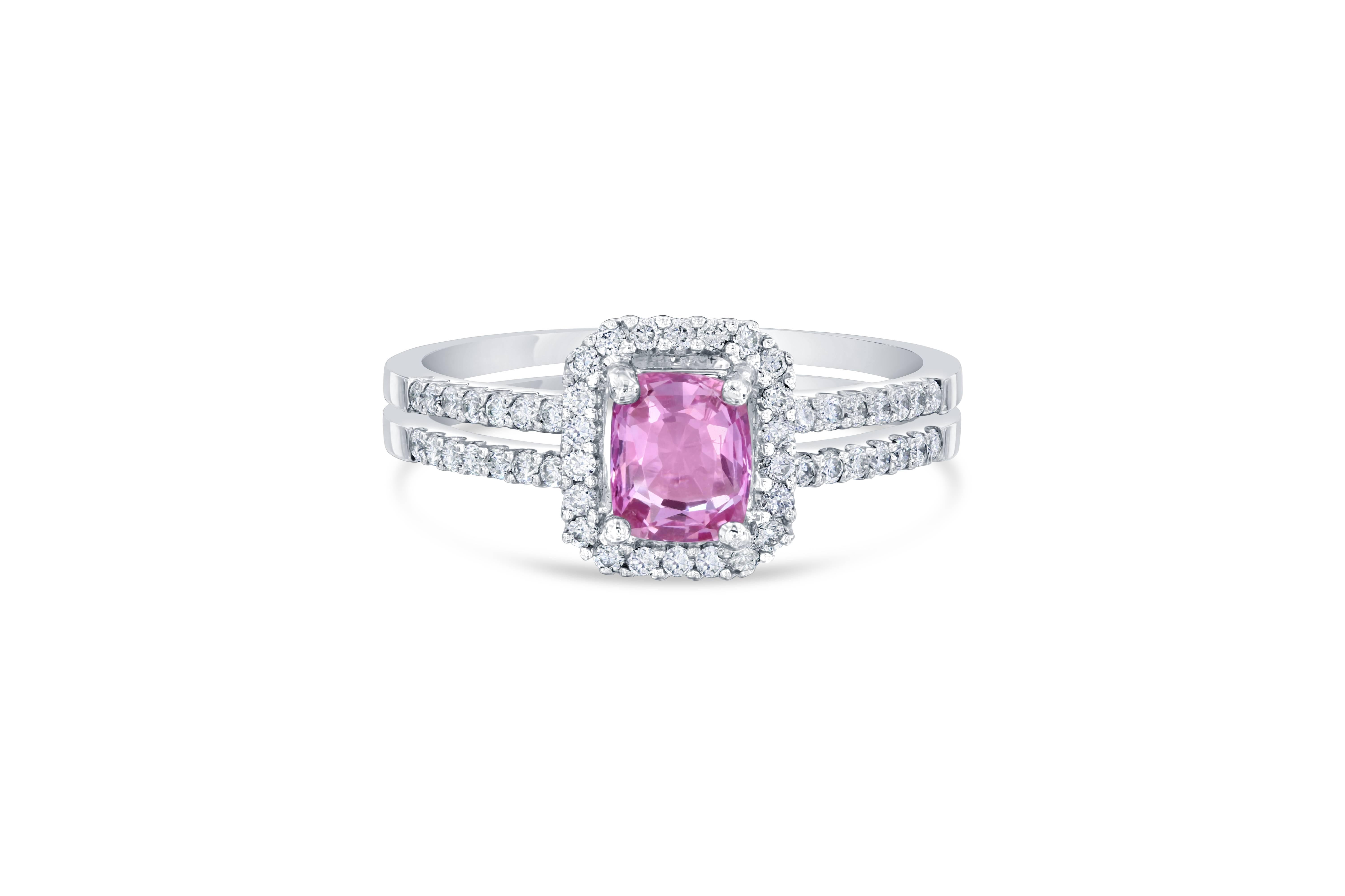 Gorgeous Pink Sapphire Diamond Ring with a beautiful setting! Can be a very unique Engagement Ring or Cocktail Ring! Also has a GIA Certificate #: 2195053396
The center Cushion Cut Pink Sapphire is 0.93 Carats surrounded by a halo and split shank of