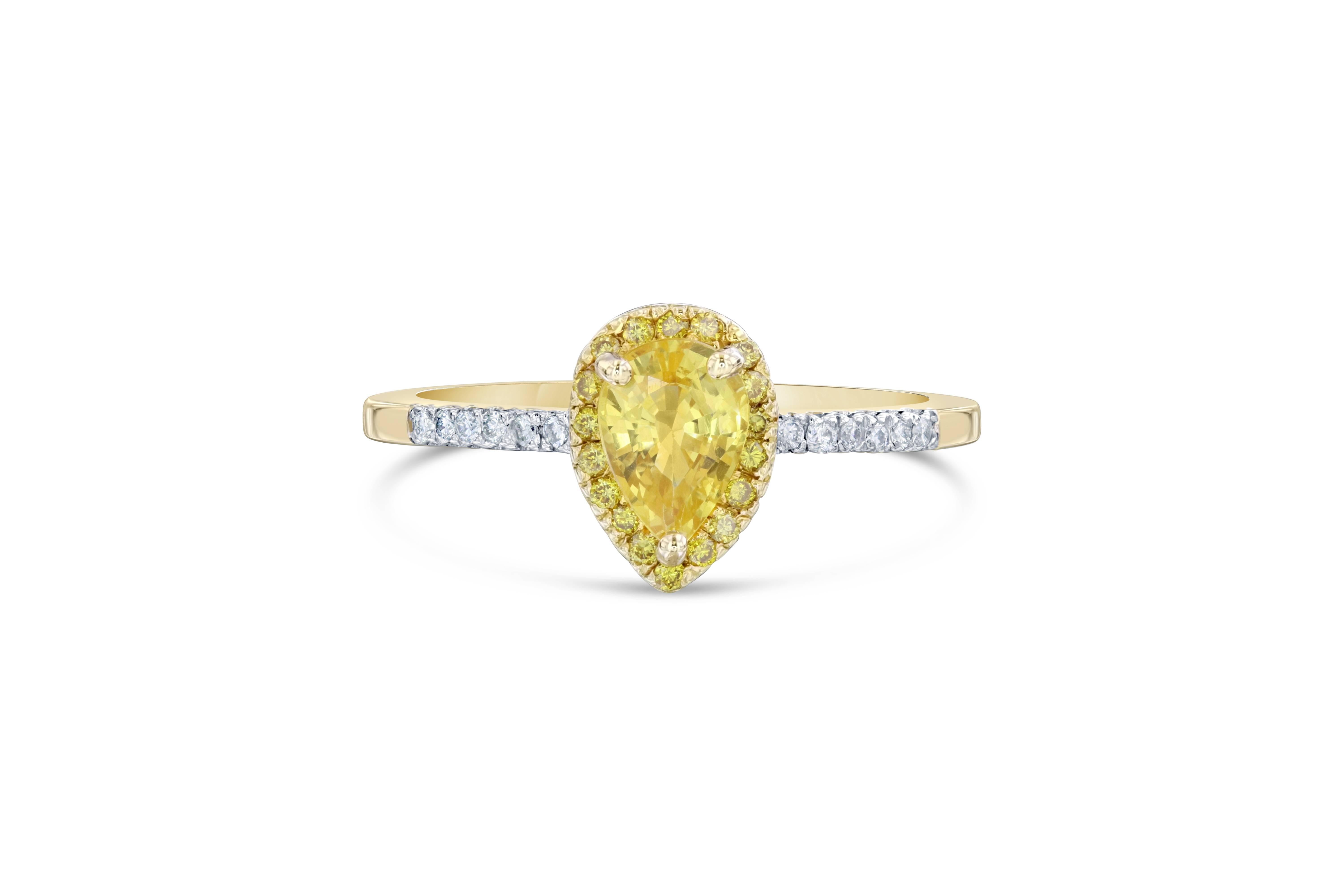 A unique Yellow Sapphire Diamond Ring that can be a beautiful Engagement Ring. 

Ring Attributes: 

Pear Cut Yellow Sapphire = 0.96 Carats.
18 Natural Fancy Yellow Diamonds = 0.14 Carats.
14 Round Cut Diamonds that weigh 0.09 Carats.
14K Yellow Gold