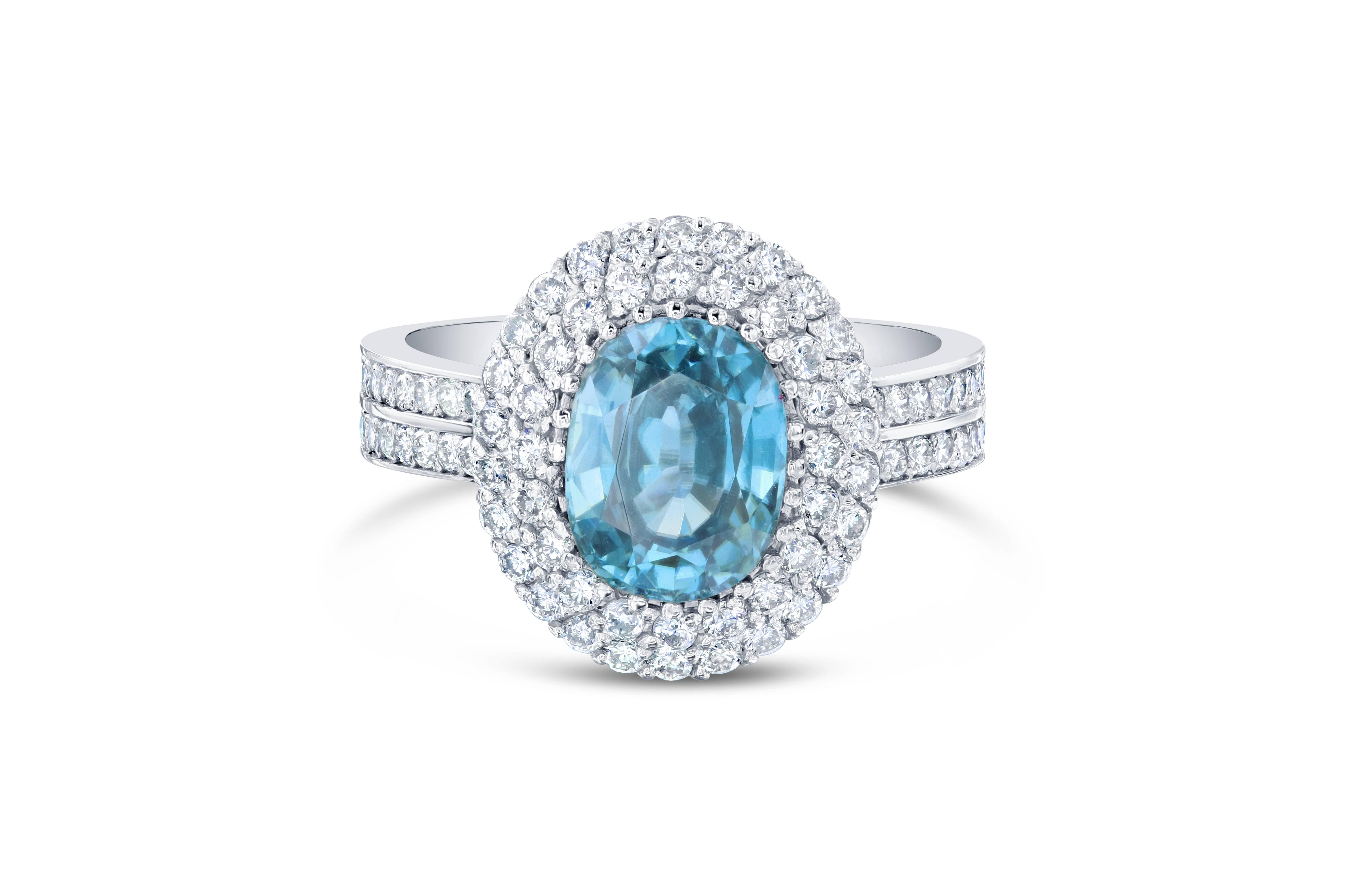 A Dazzling Blue Zircon and Diamond Ring! Blue Zircon is a natural stone mined in different parts of the world, mainly Sri Lanka, Myanmar, and Australia. 

This Oval Cut Blue Zircon is 3.53 Carats surrounded by a double halo of 82 Round Cut Diamonds