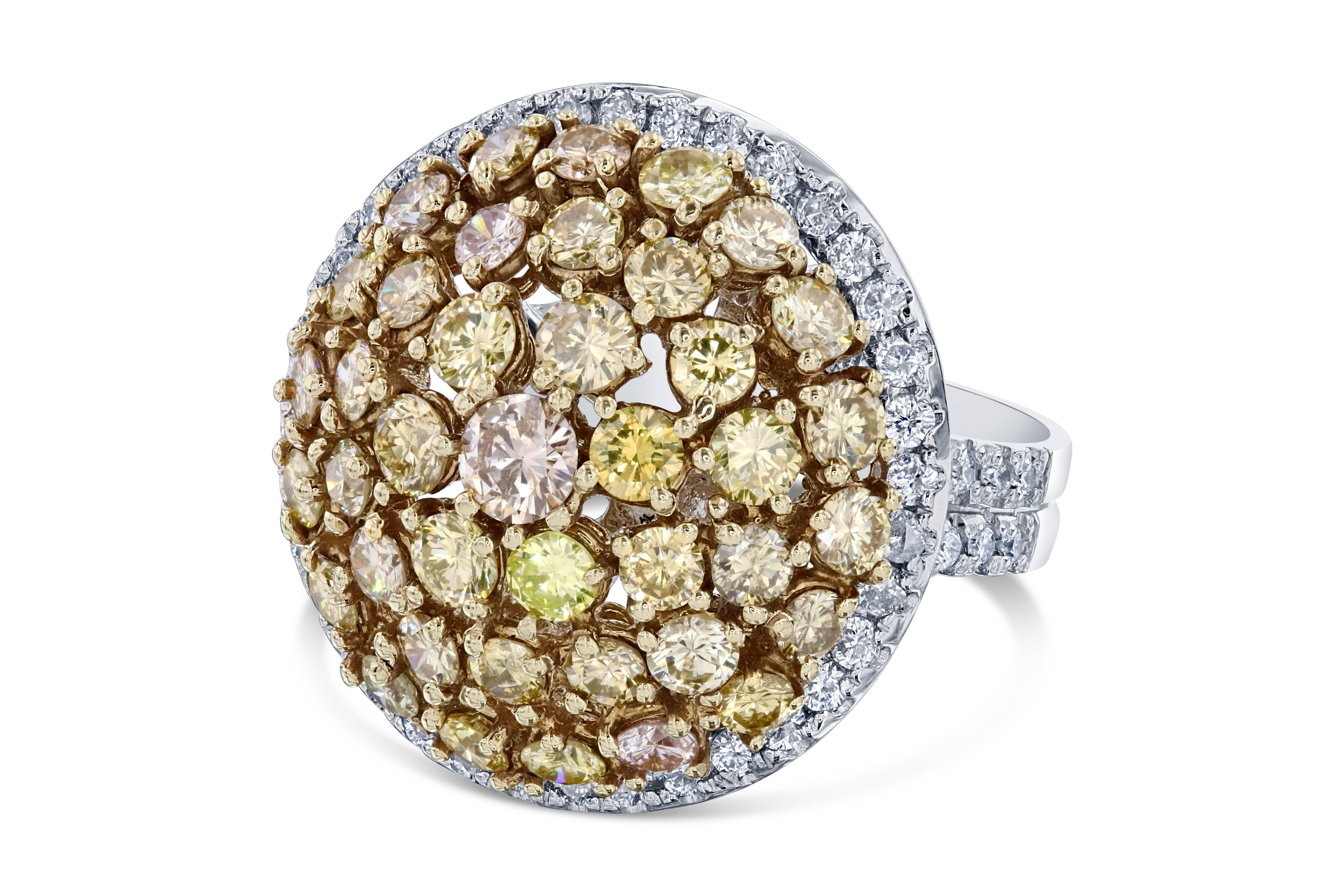 Elegance and beauty at its best - a real show stopper!   There are 40 Round Cut Fancy Colored Diamonds that weigh 4.35 carats clustered around the center of the ring.  These diamonds are natural in color and the clarity is a SI2.  There are also 64