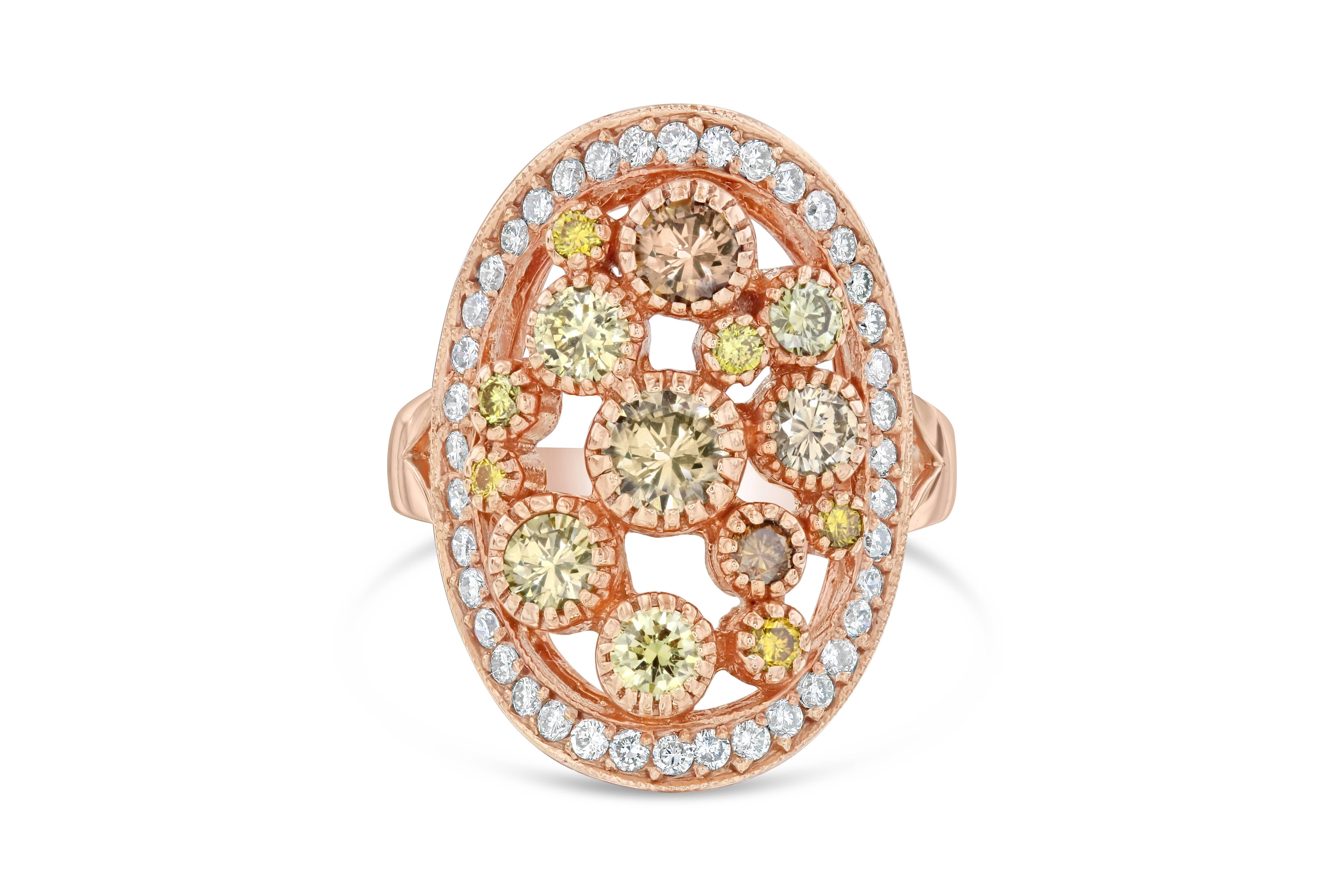 We like to call this ring a bubble gum cocktail ring!  There are 14 Round Cut Fancy Colored Diamonds that weigh 1.39 carats floating around the center of the ring.  The colors and sizes of the diamonds vary from dark brown to light yellow and some