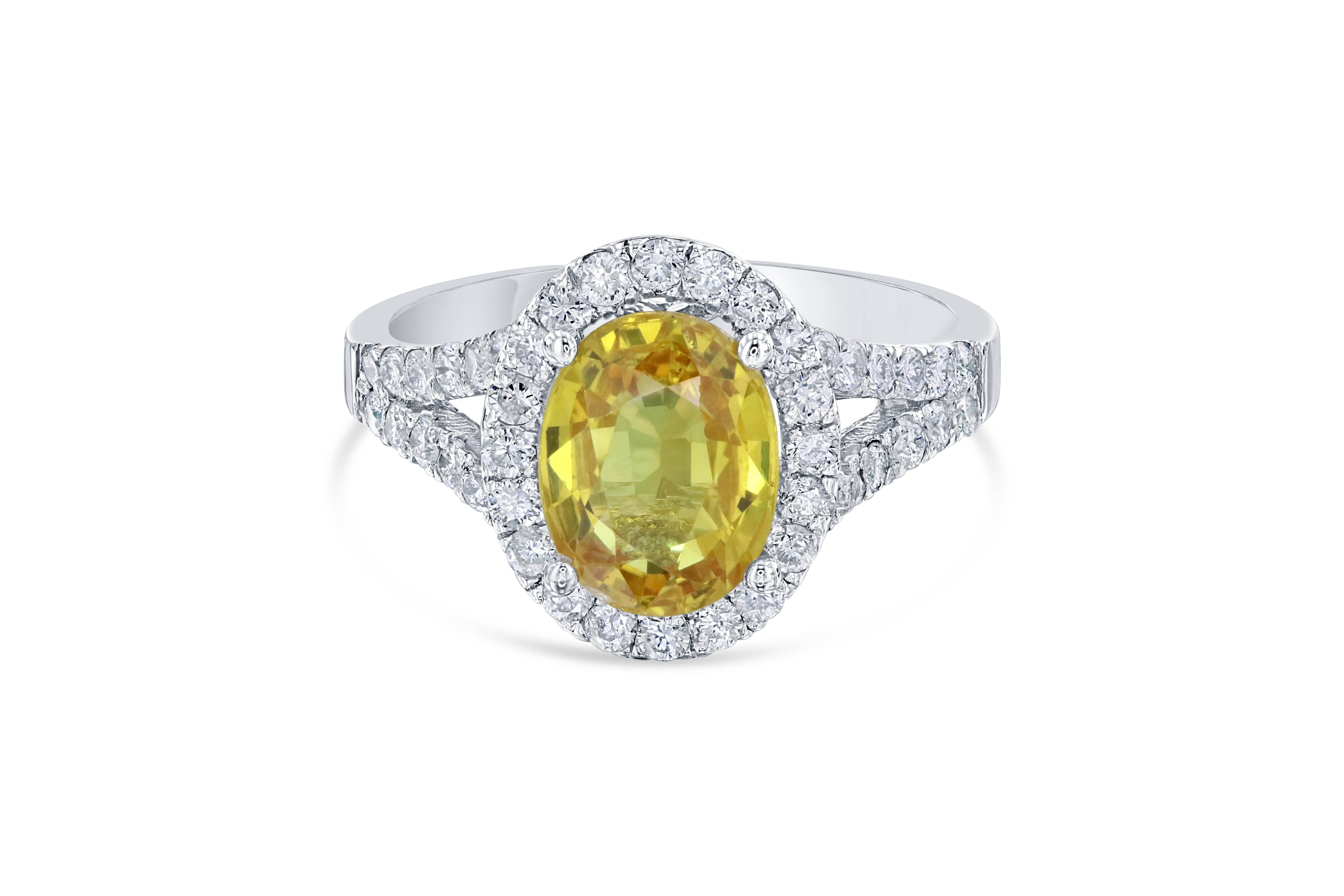 A unique Yellow Sapphire Diamond Ring that can be a beautiful Engagement Ring. The Oval Cut Yellow Sapphire is 2.77 Carats. It has a halo of 44 Round Cut Diamonds that weigh 0.72 Carats. The total carat weight of the ring is 3.49 Carats. 
It is set