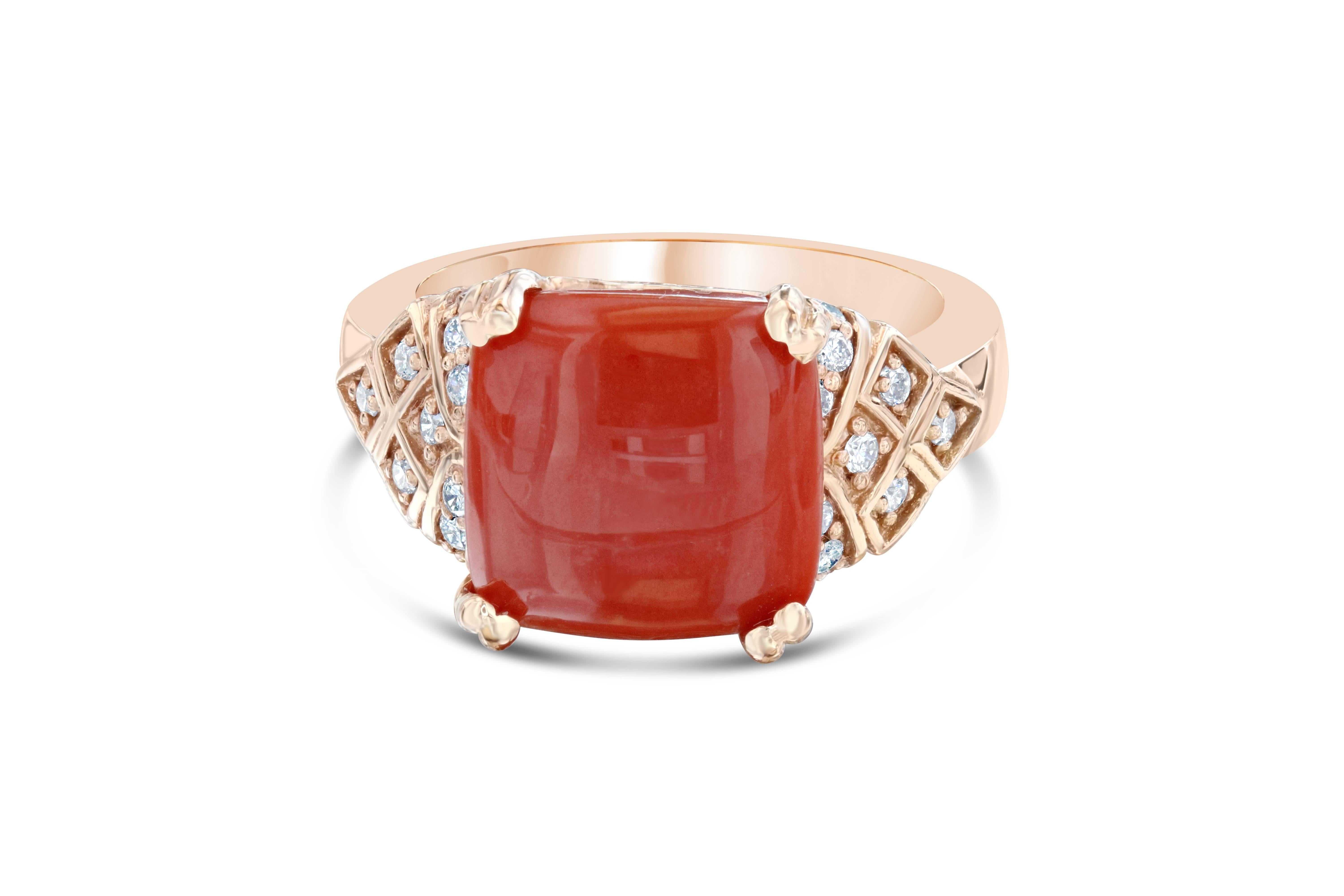 The Coral is 4.39 Carats and is surrounded by 36 Round Cut Diamonds weighing 0.61 Carats.  The Total Carat Weight of the ring is 5.00 Carats. 

It is crafted in 14K Rose Gold and weighs 7.8 grams. 

The ring is a size 7 and can be resized, if
