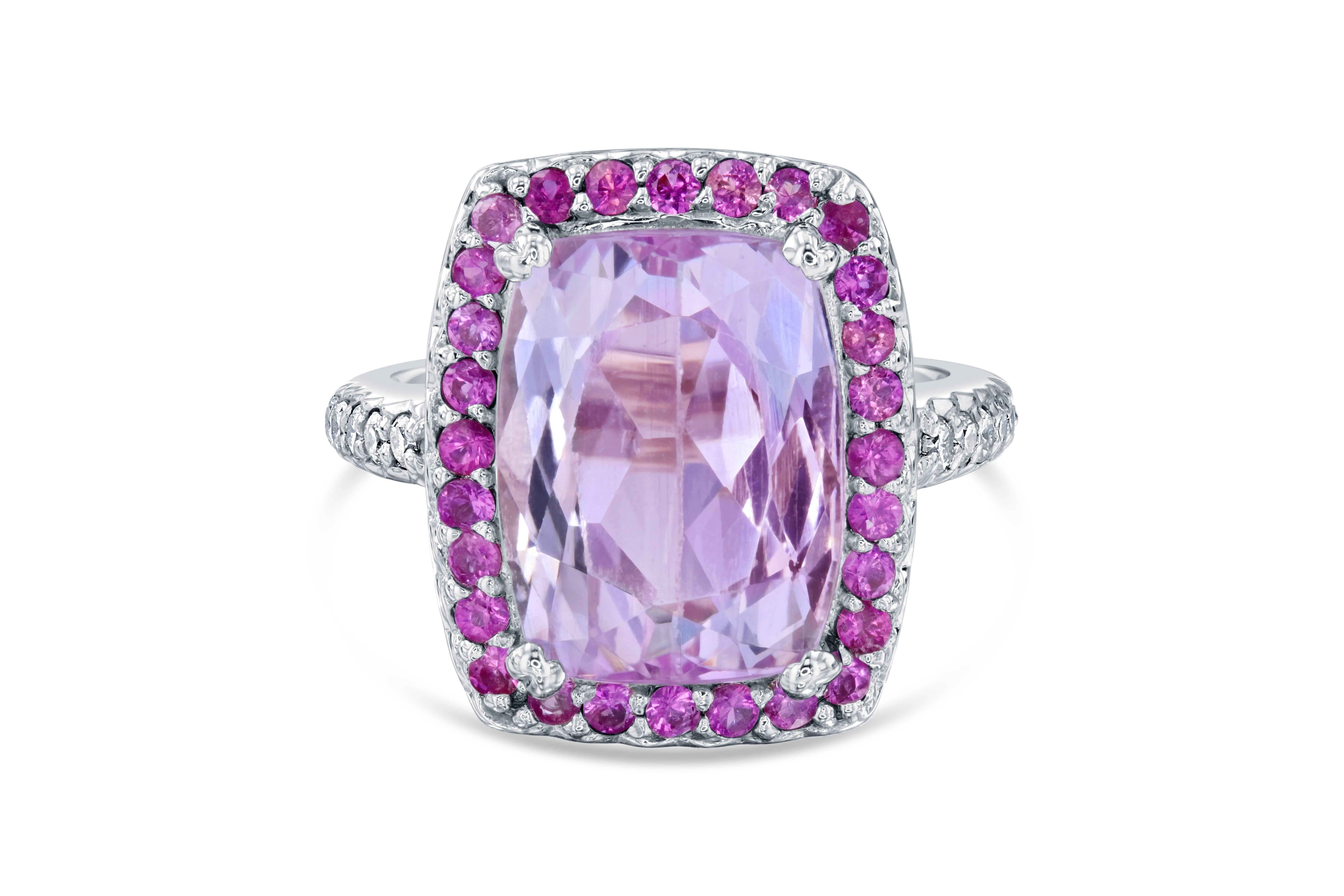 This beautiful ring has a huge 7.85 carat Kunzite that is set in the center of the ring and is surrounded by 30 Round Cut Pink Sapphires that weigh 0.80 carat.  This ring also has 10 Round Cut Diamonds that weigh 0.23 carat and are set along the