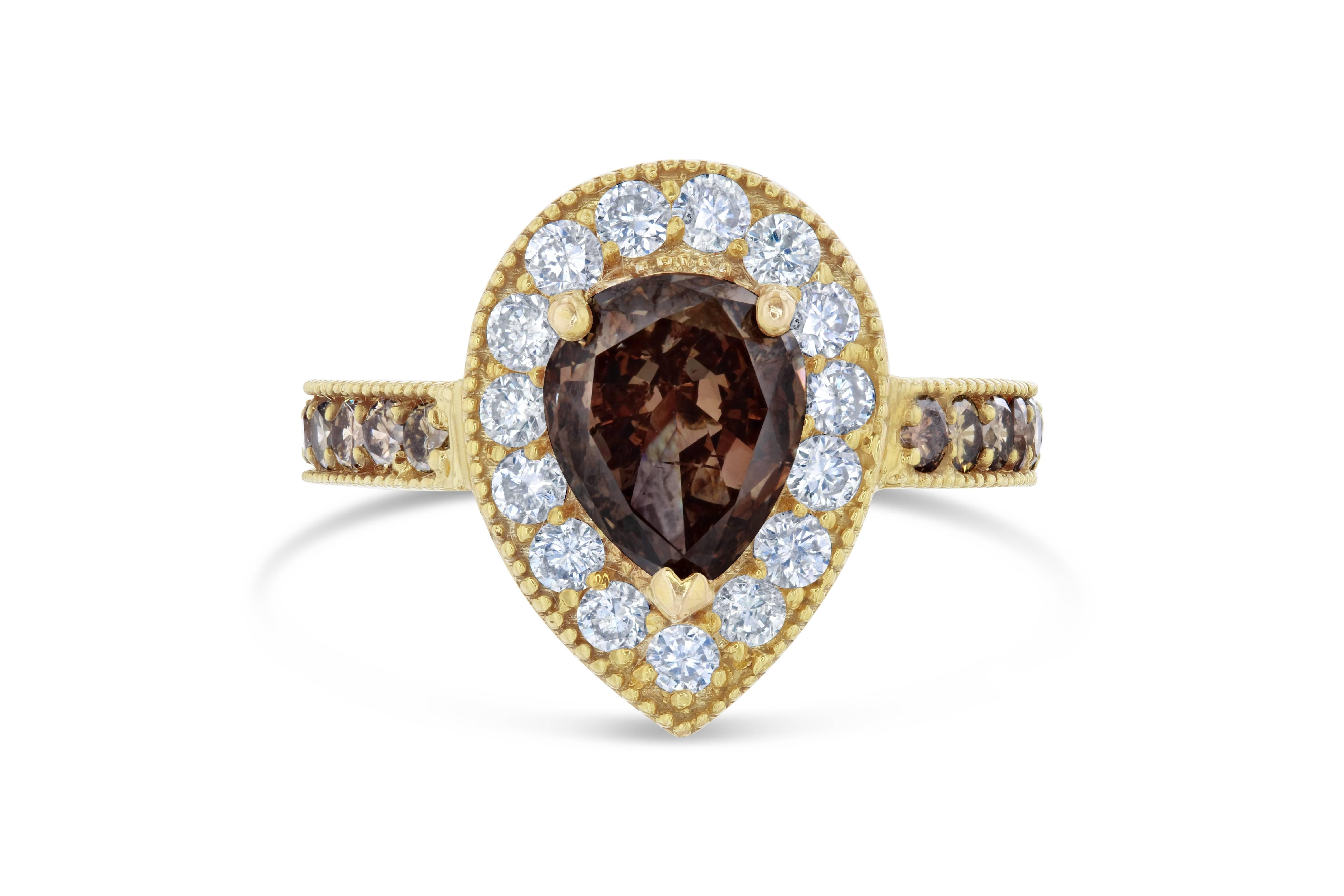 This versatile victorian-inspired ring can be an engagement ring, cocktail or simply an everyday ring!

The center diamond is a natural, fancy colored pear cut brown diamond weighing 1.68 carats. The ring is surrounded by a single halo of 15 round