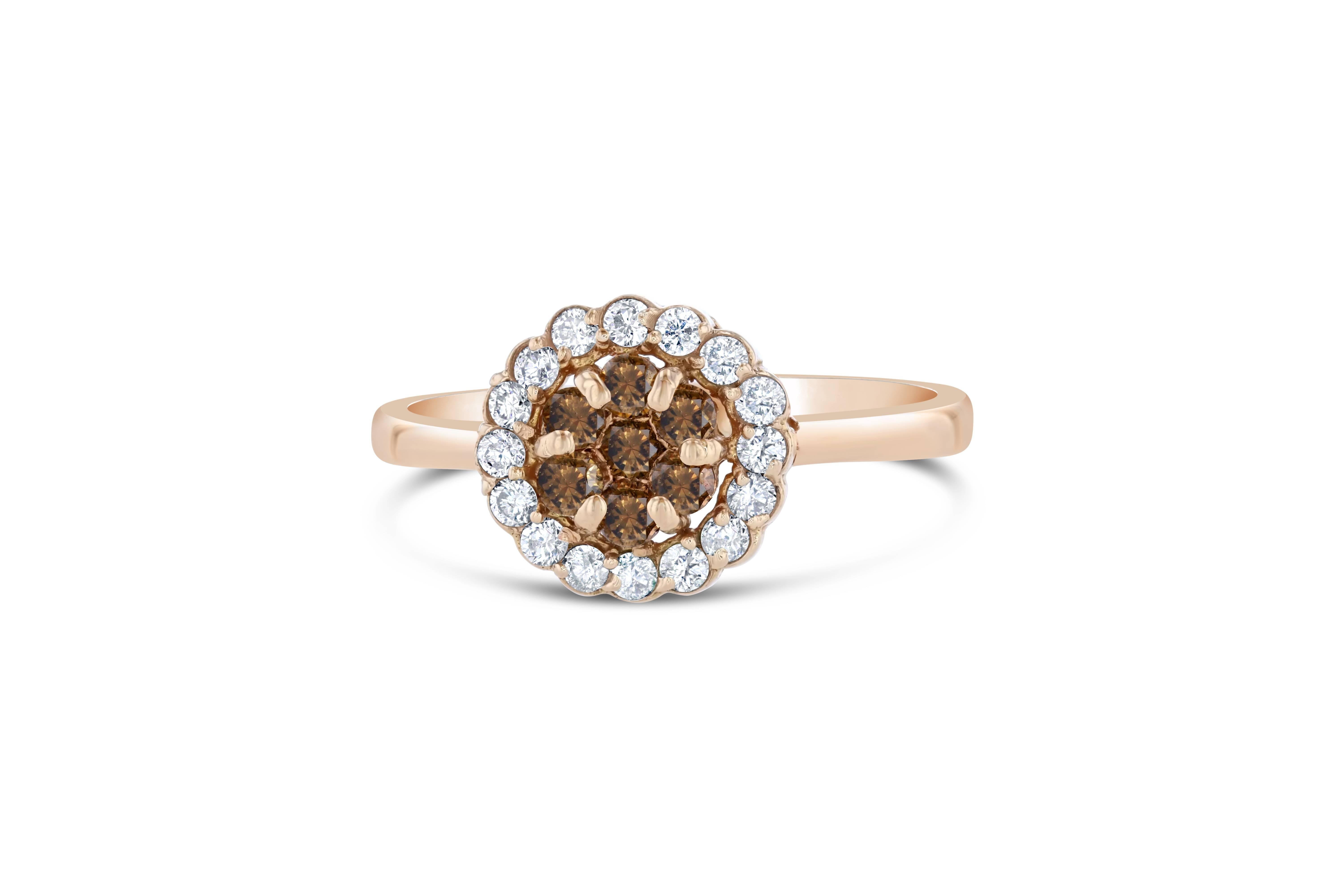 This is a cute and dainty cluster ring that gives the illusion of a flower in the center of the ring.

There are 7 natural and fancy colored brown round cut diamonds that weigh 0.27 carat and there are 16 white round cut diamonds that weigh 0.27