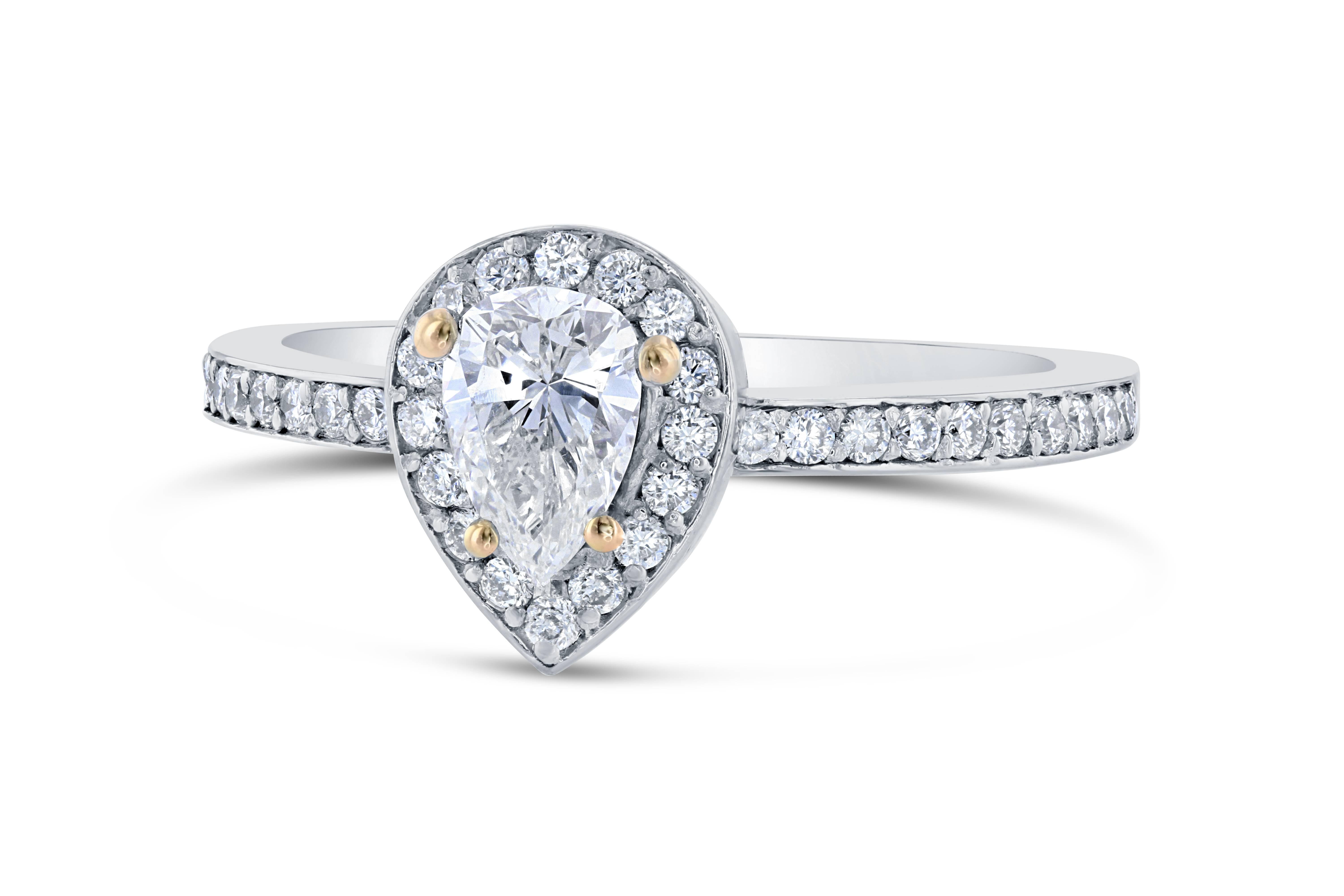 A beautiful pear cut diamond ring that can be an engagement, bridal, or an everyday ring!

The center Pear Cut Diamond is 0.47 Carats surrounded by a halo of 36 Round Cut Diamonds that weigh 0.31 Carats. The clarity and color of both the center and