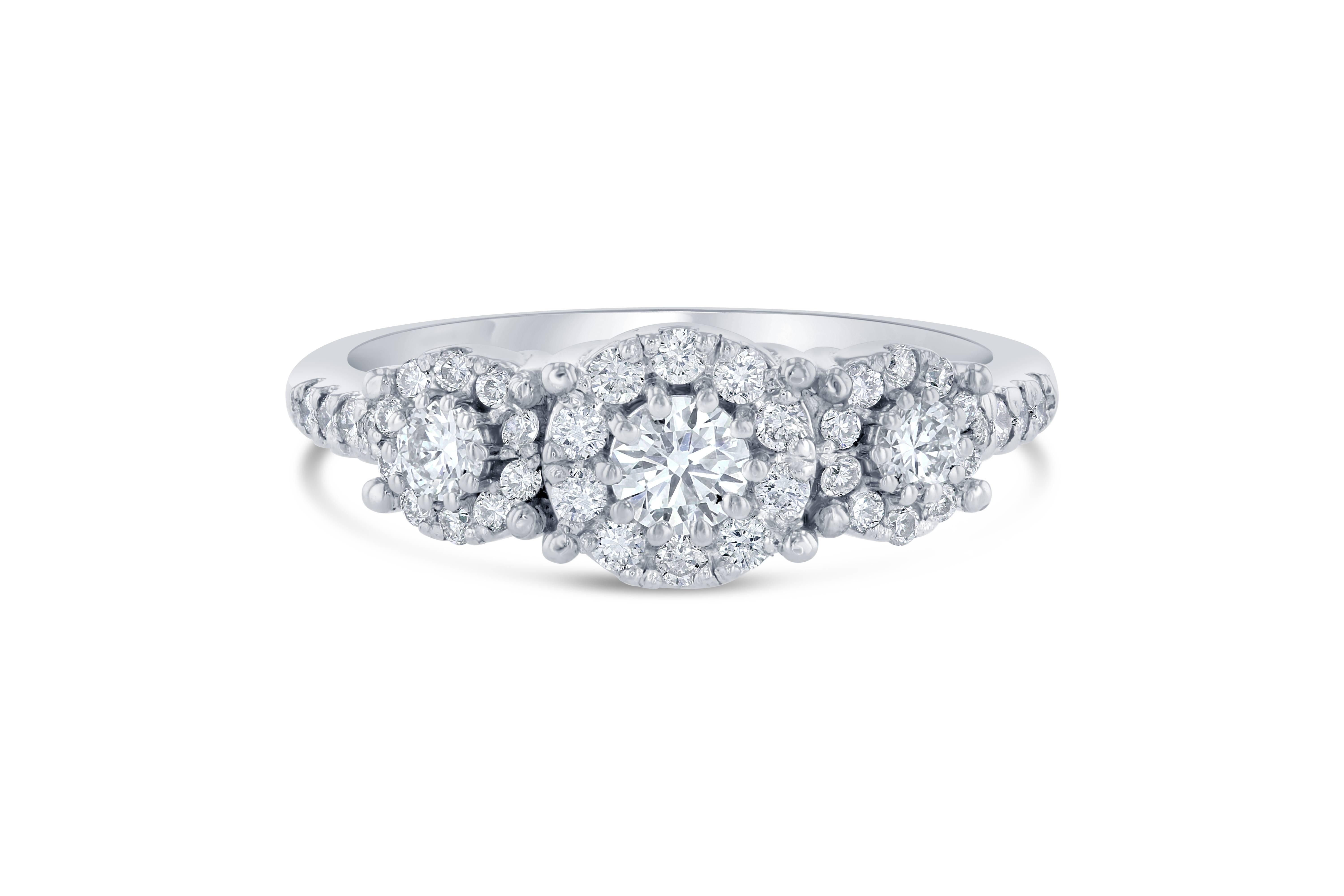 A beautiful round cut diamond three stone ring set in a round invisible setting creating a larger look for the entire ring!

There are 41 Round Cut Diamonds that weigh 0.68 Carats and includes the three center diamonds and the surrounding diamonds
