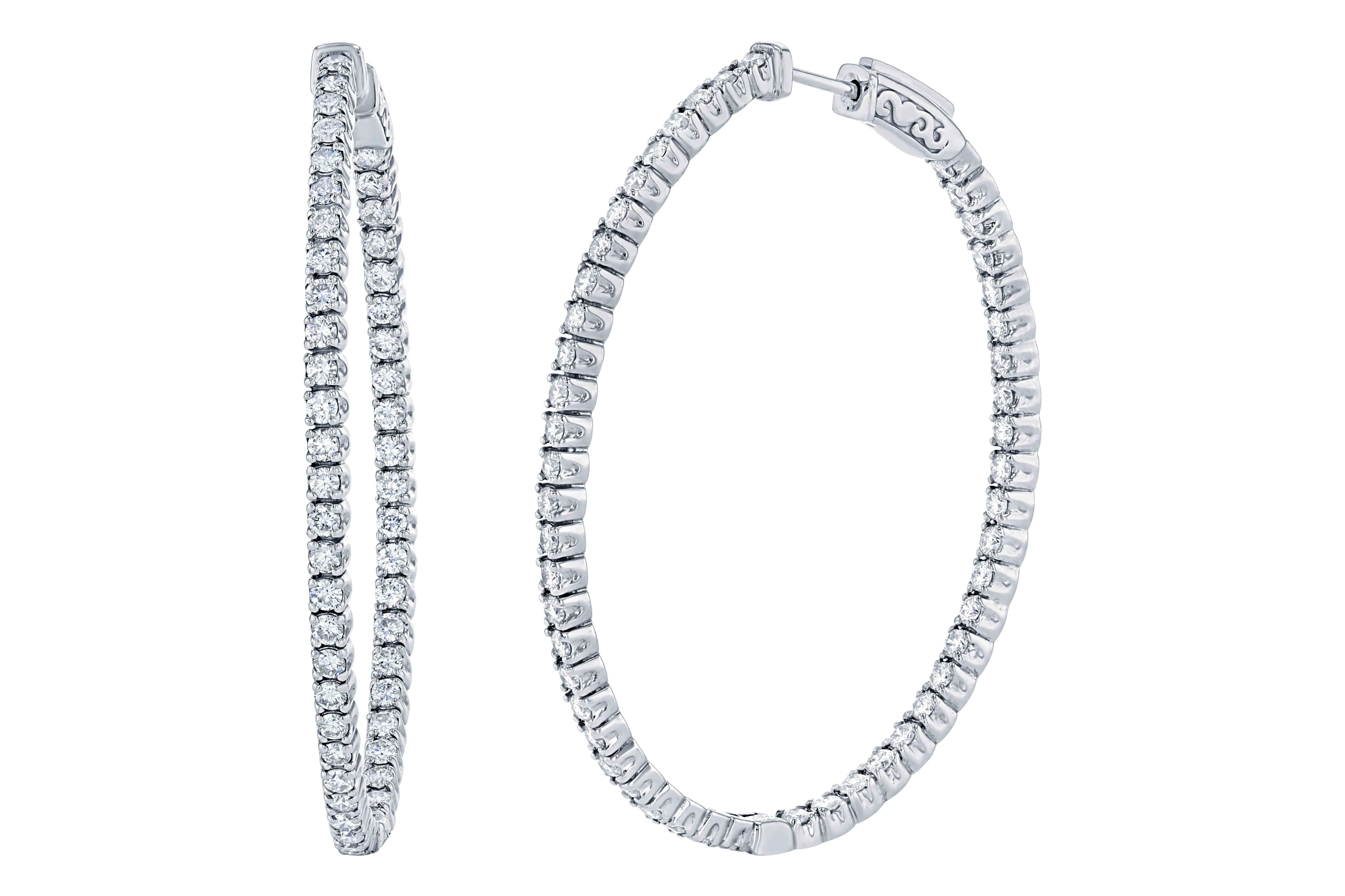 These stunning diamond hoops have diamonds set inside and out to give the piece symmetry and sparkle from all angles.  There are 100 Round Cut Diamonds that weigh 2.97 carats and they are made in 14K White Gold and weigh approximately 13.9 grams.