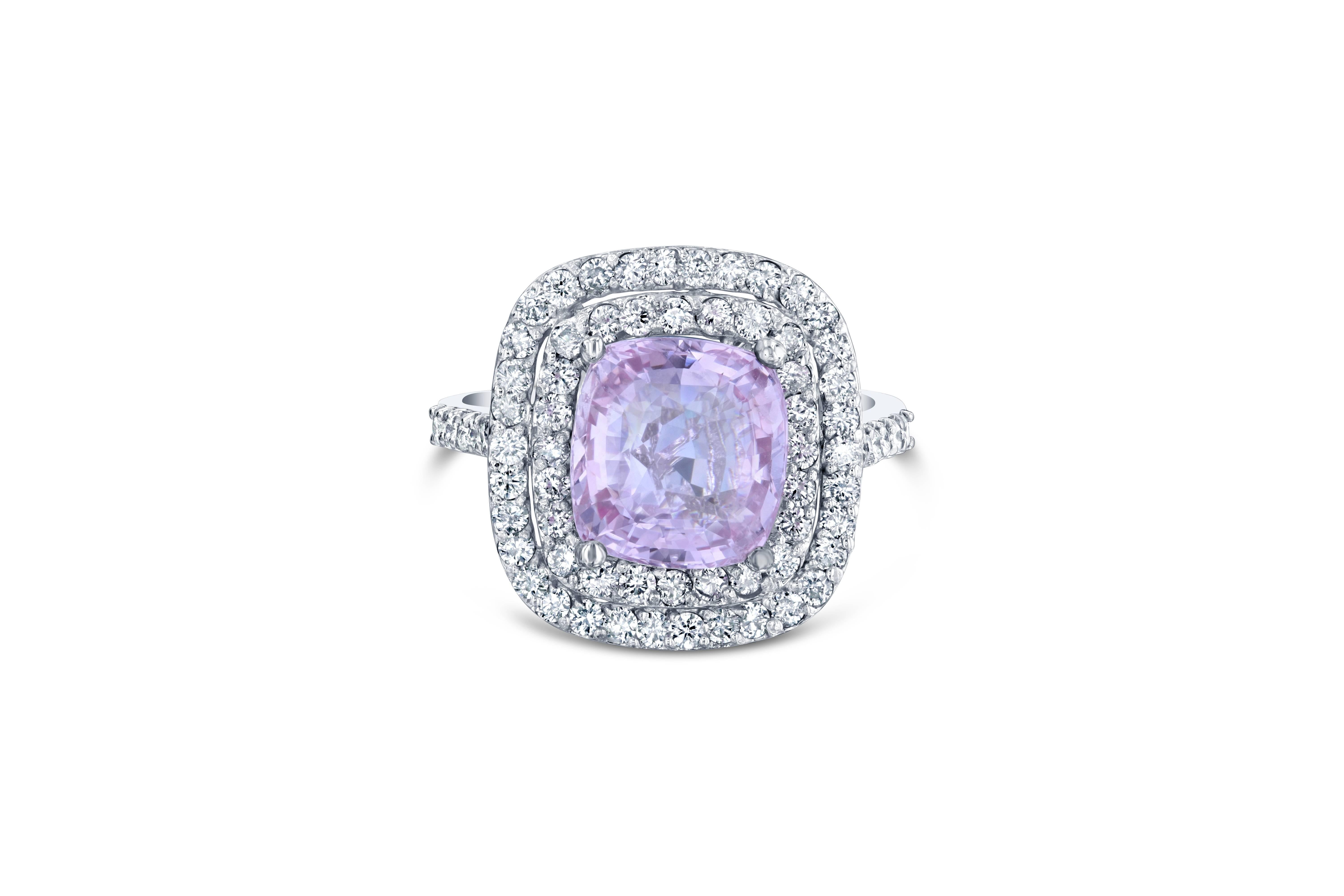 Gorgeous double halo engagement ring alternative! This ring has a Cushion Cut 4.70 carat Pink Sapphire in the center of the ring and is surrounded by a double halo of 72 Round Cut Diamonds that weigh 1.05 carats (Clarity: SI2, Color: F). The total