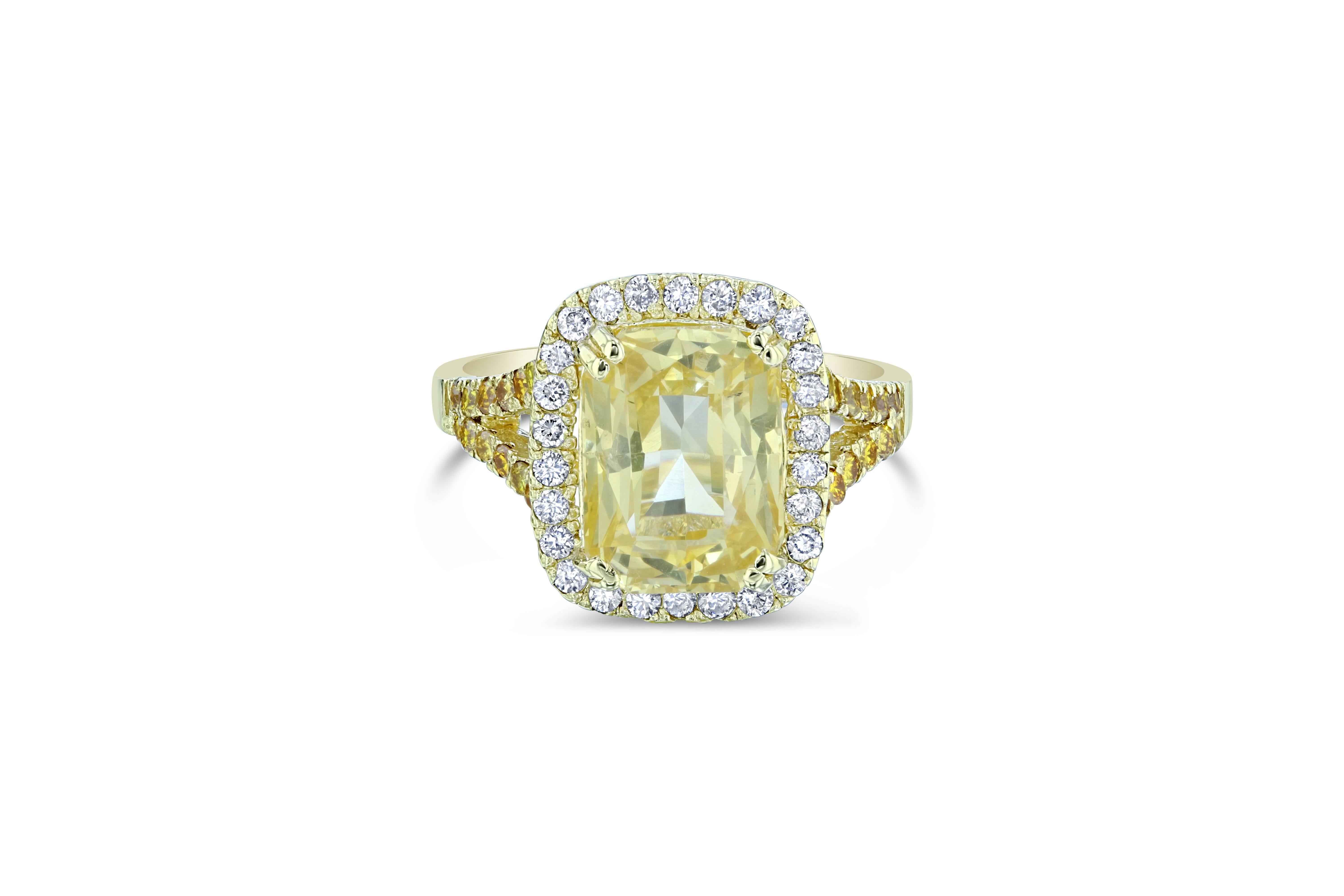 A gorgeous Yellow Sapphire Ring in a unique setting! This gorgeous Yellow Sapphire is a natural, no heat Sapphire that weighs 5.70 carats. 
It has a halo of 26 Round Cut Diamonds that weigh 0.34 carat (Clarity: VS2, Color: H).  The shank of the ring