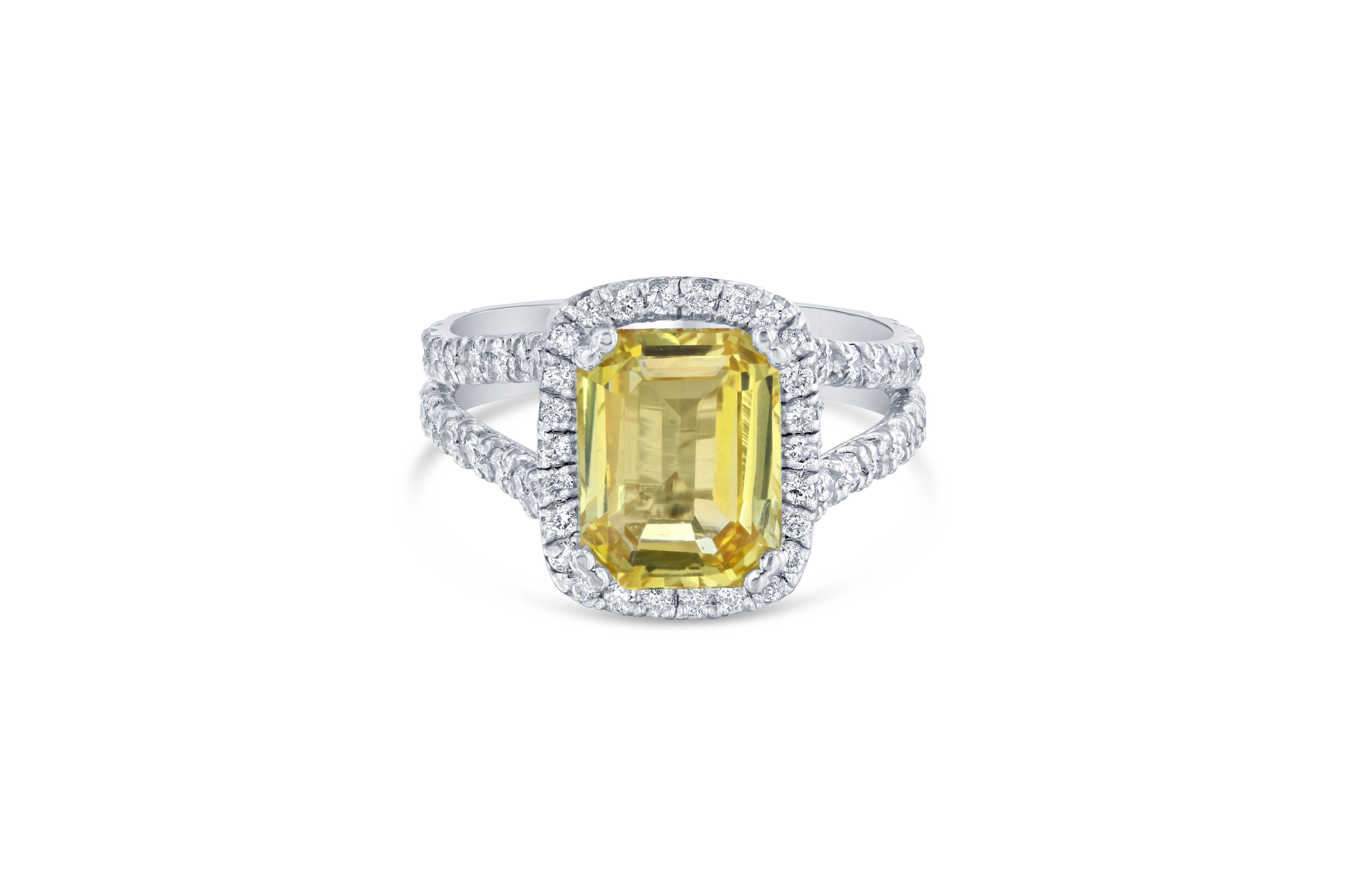 A gorgeous Yellow Sapphire Ring in a classic halo setting! This gorgeous Yellow Sapphire is a natural, no heat Sapphire that weighs 5.27 carats. 
It has a halo of 94 Round Cut Diamonds that weigh 1.23 carats (Clarity: VS2, Color: H). 
The total